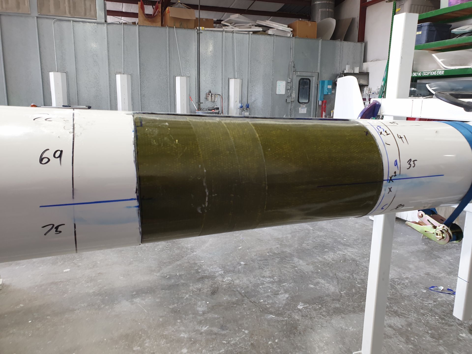 A green and white pipe with the number 69 on it