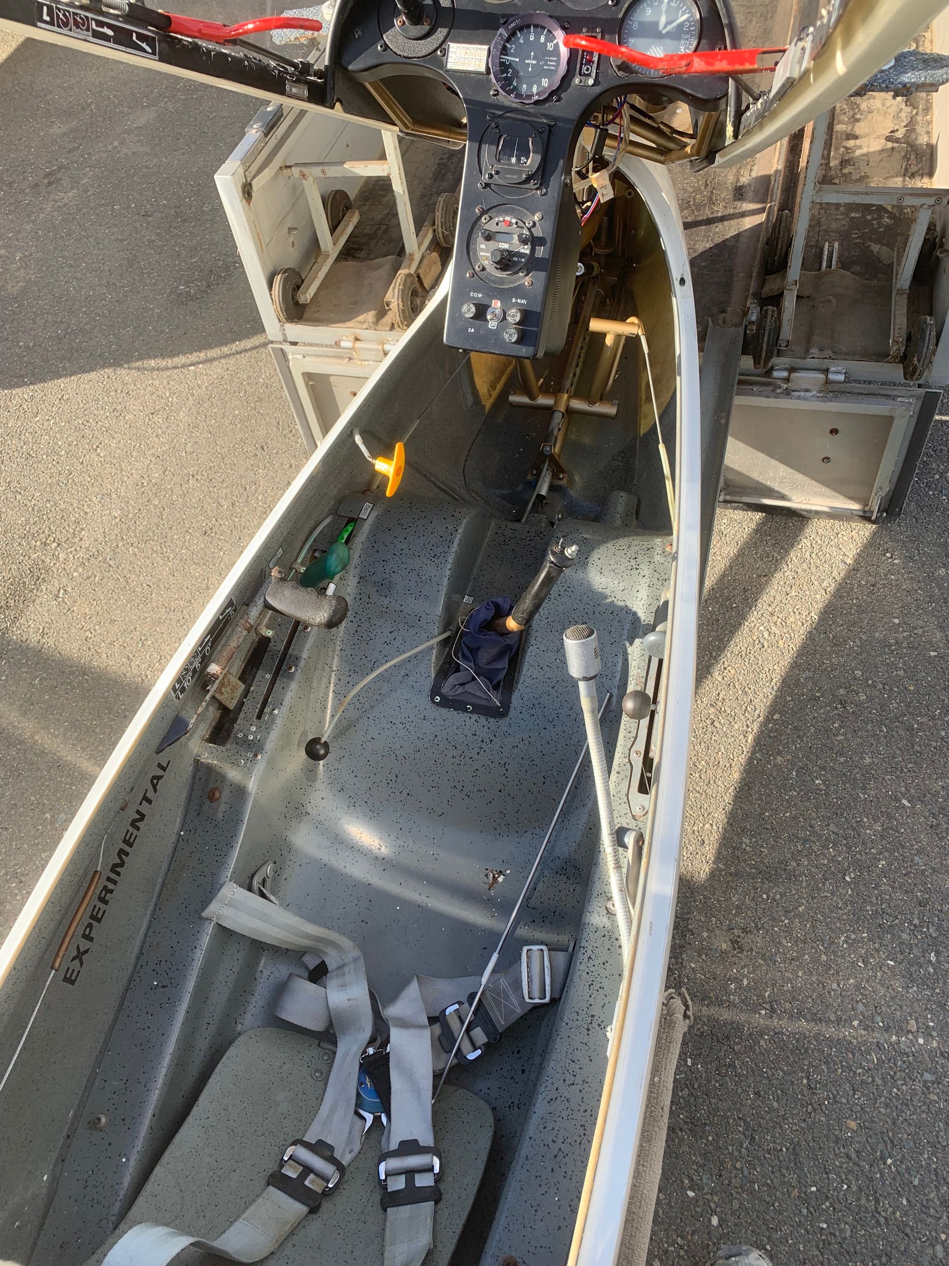 The inside of a plane with a seat and a dashboard.