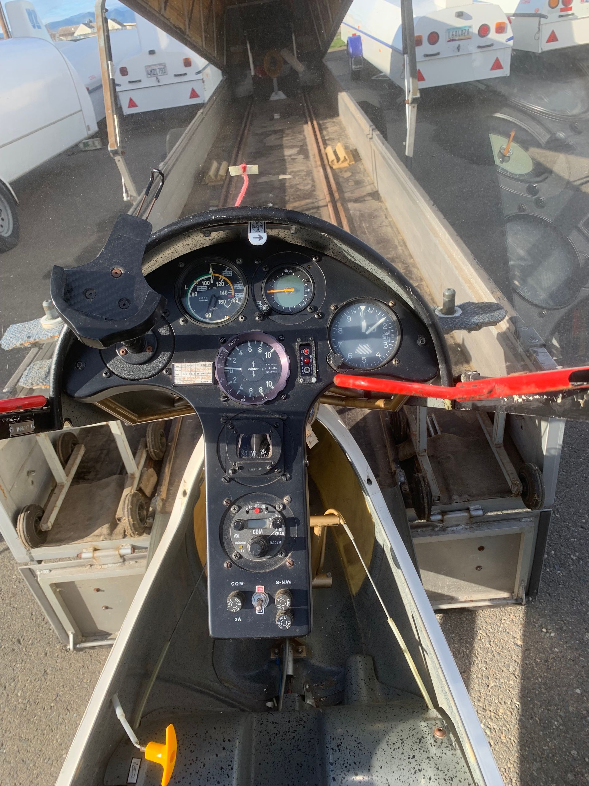 A cockpit of an airplane with a clock on it