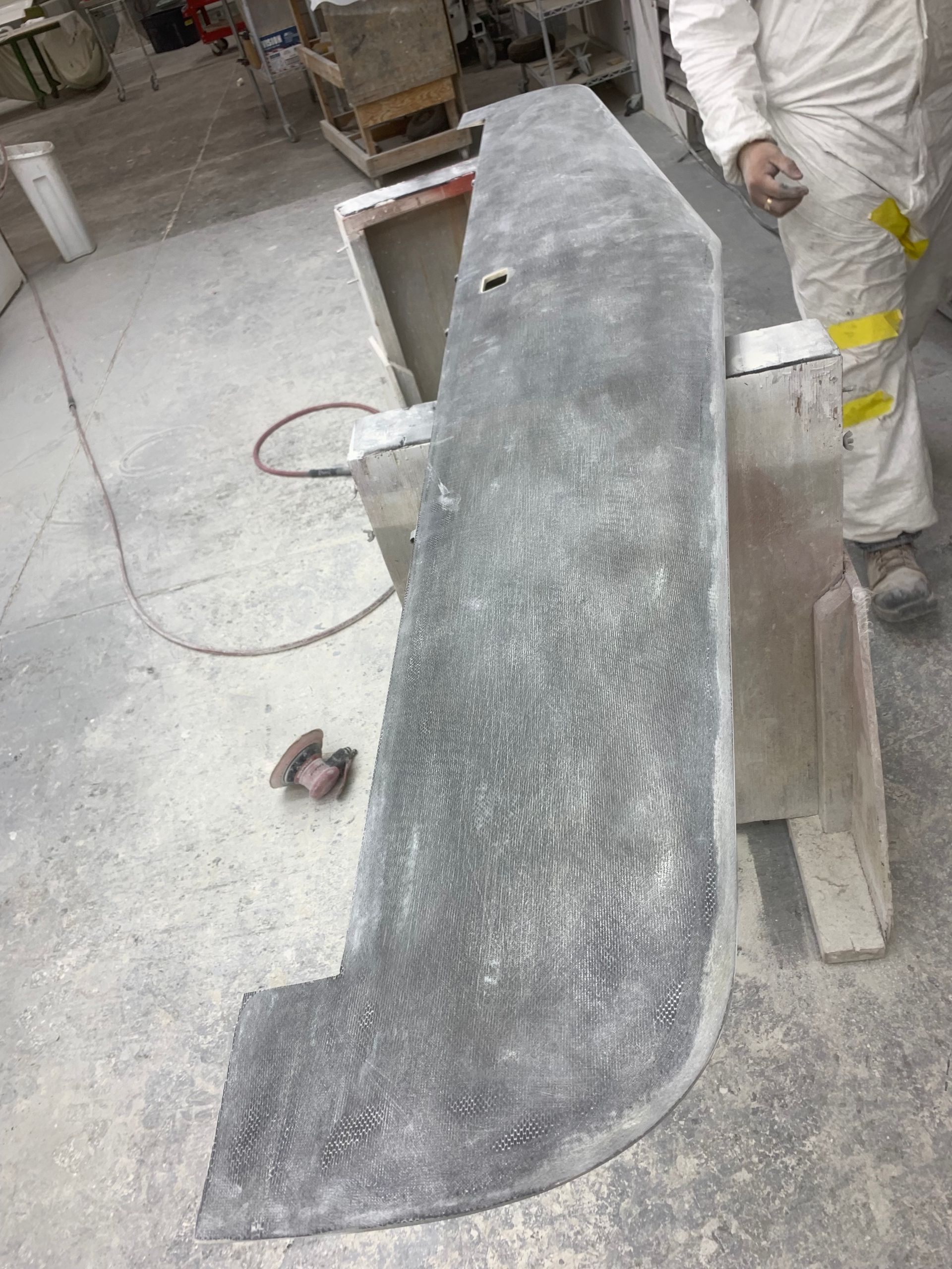 A man is standing next to a large piece of concrete.