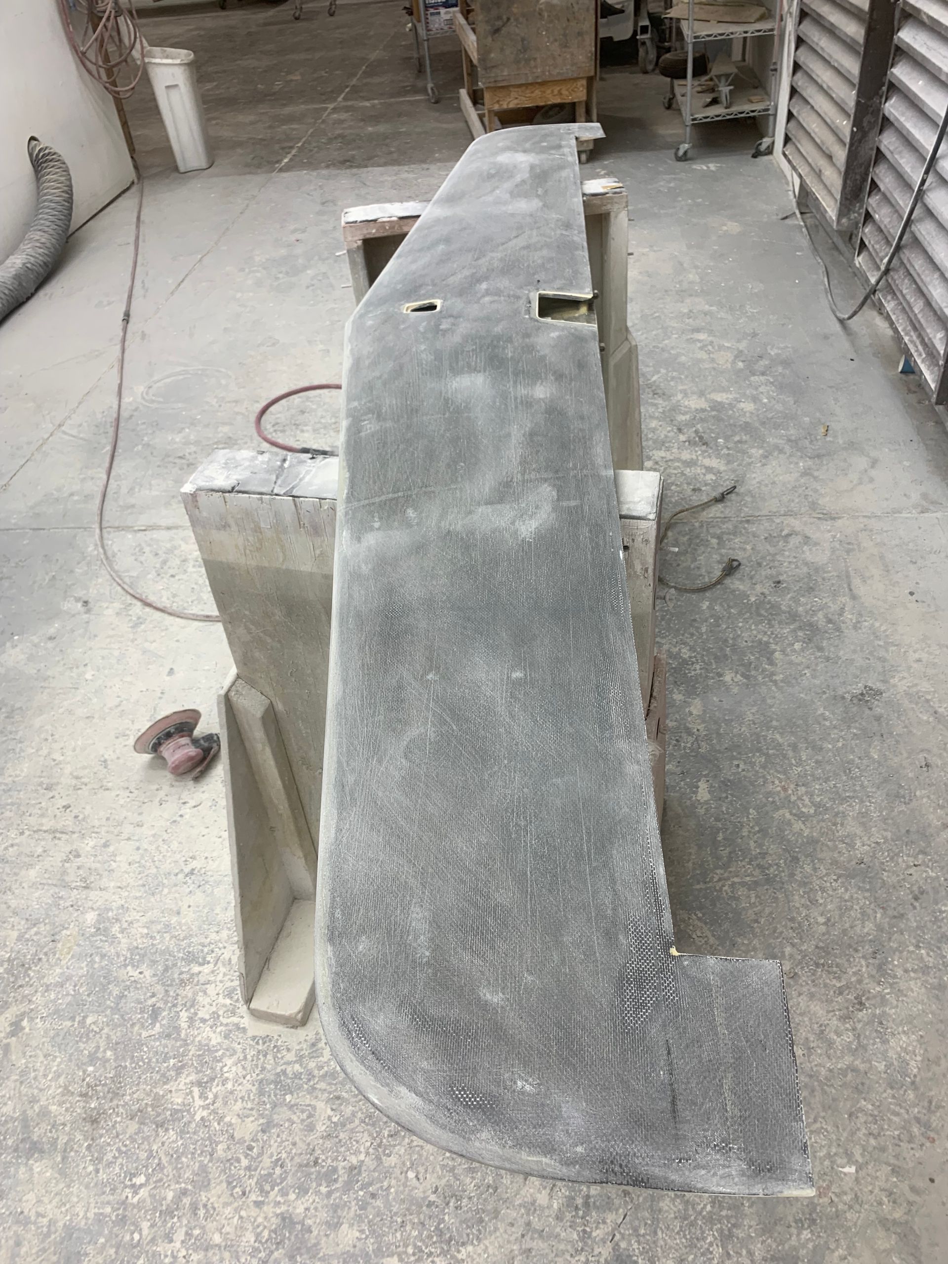 A large piece of concrete is sitting on top of a cement floor.