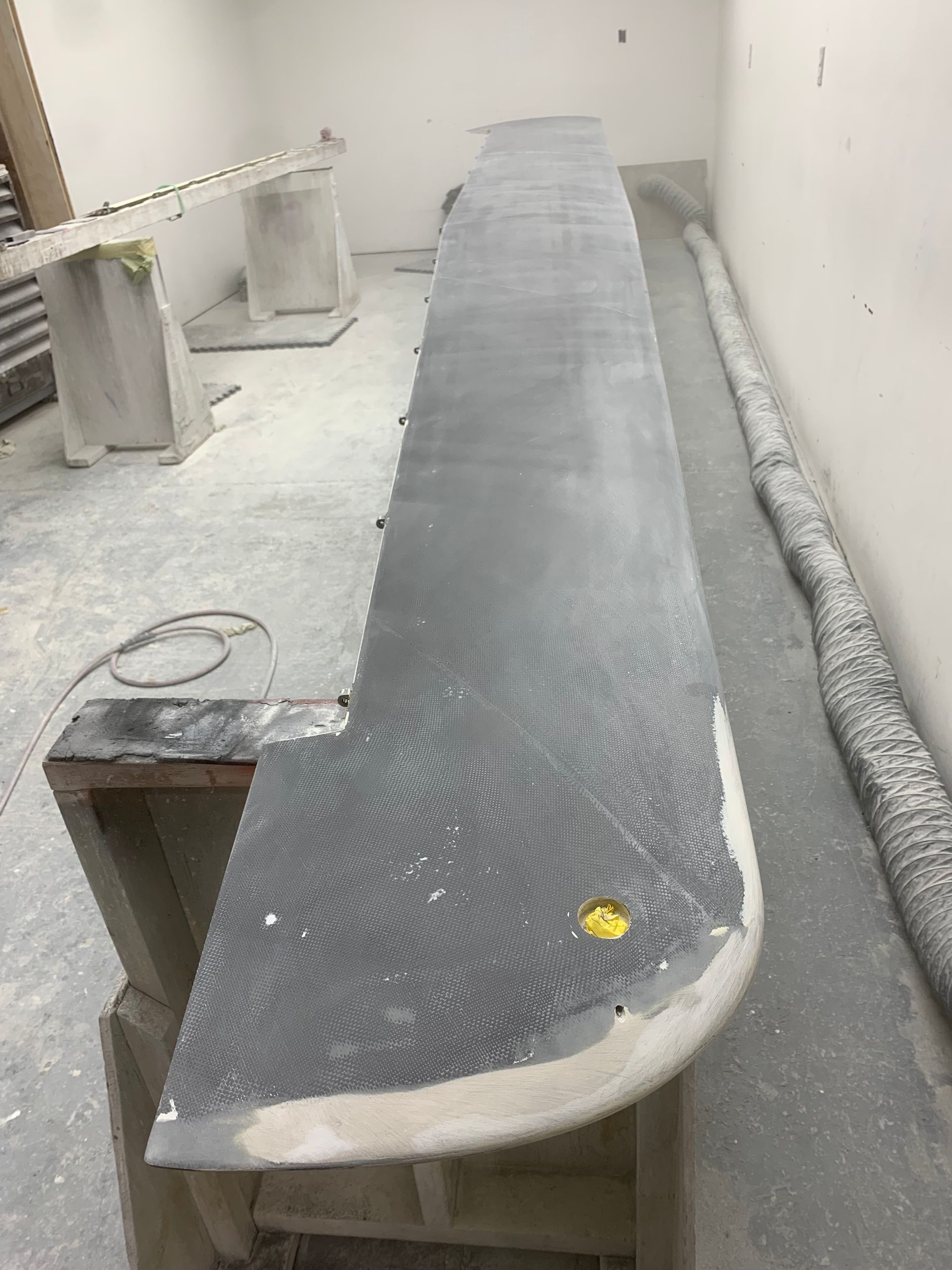 A long piece of wood is sitting on the floor in a room.