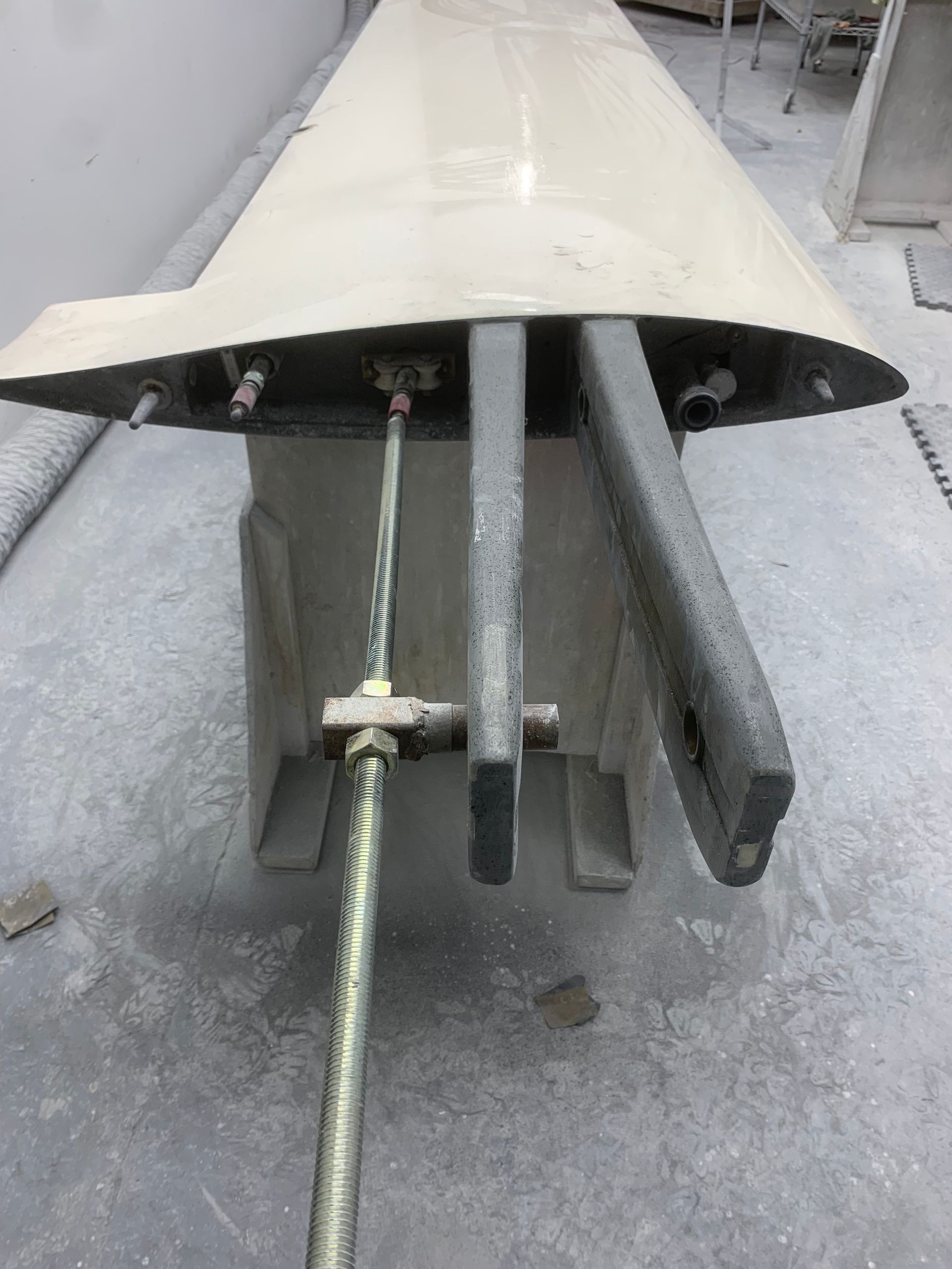 A large piece of metal is sitting on a concrete surface.