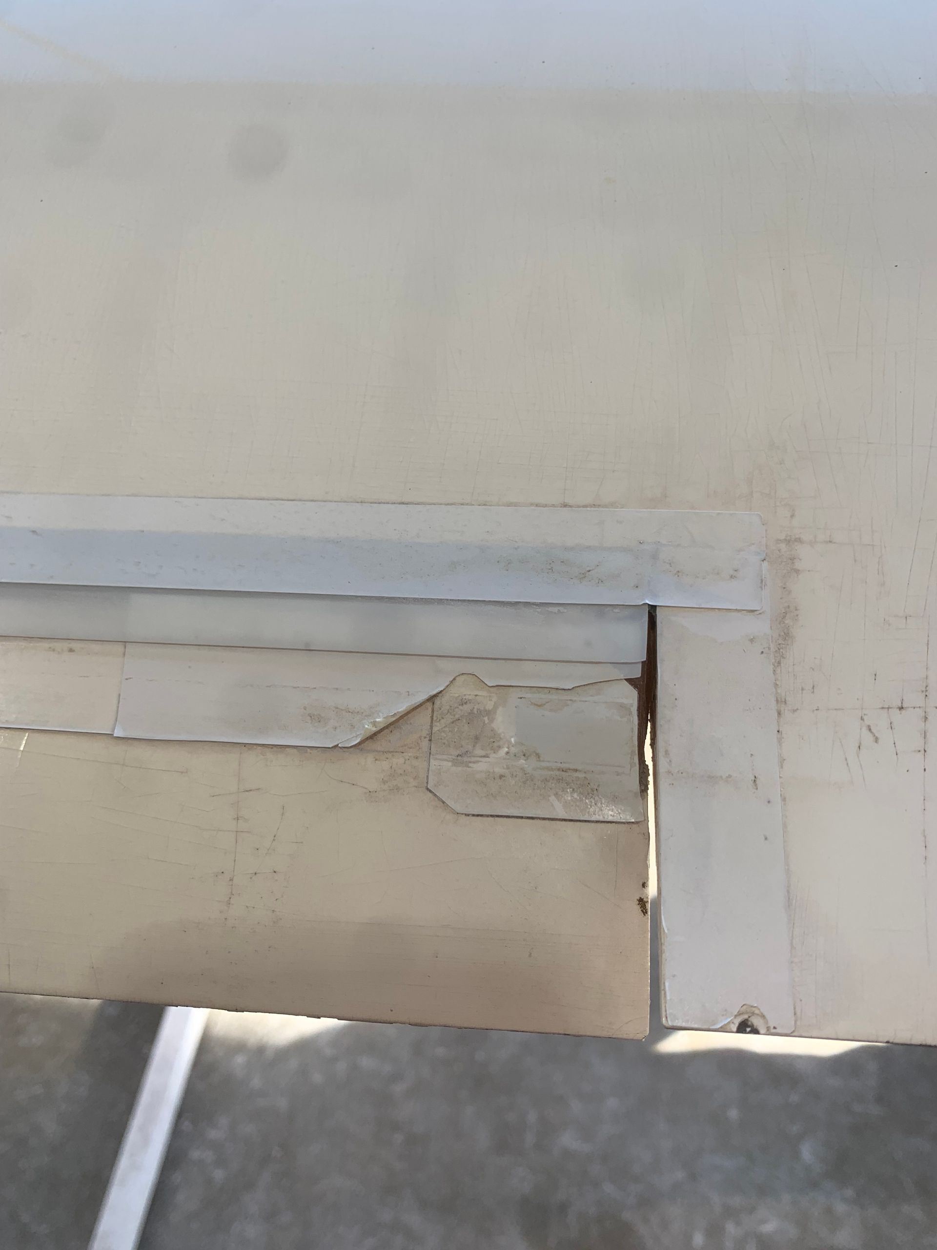 A close up of a white wall with a hole in it.