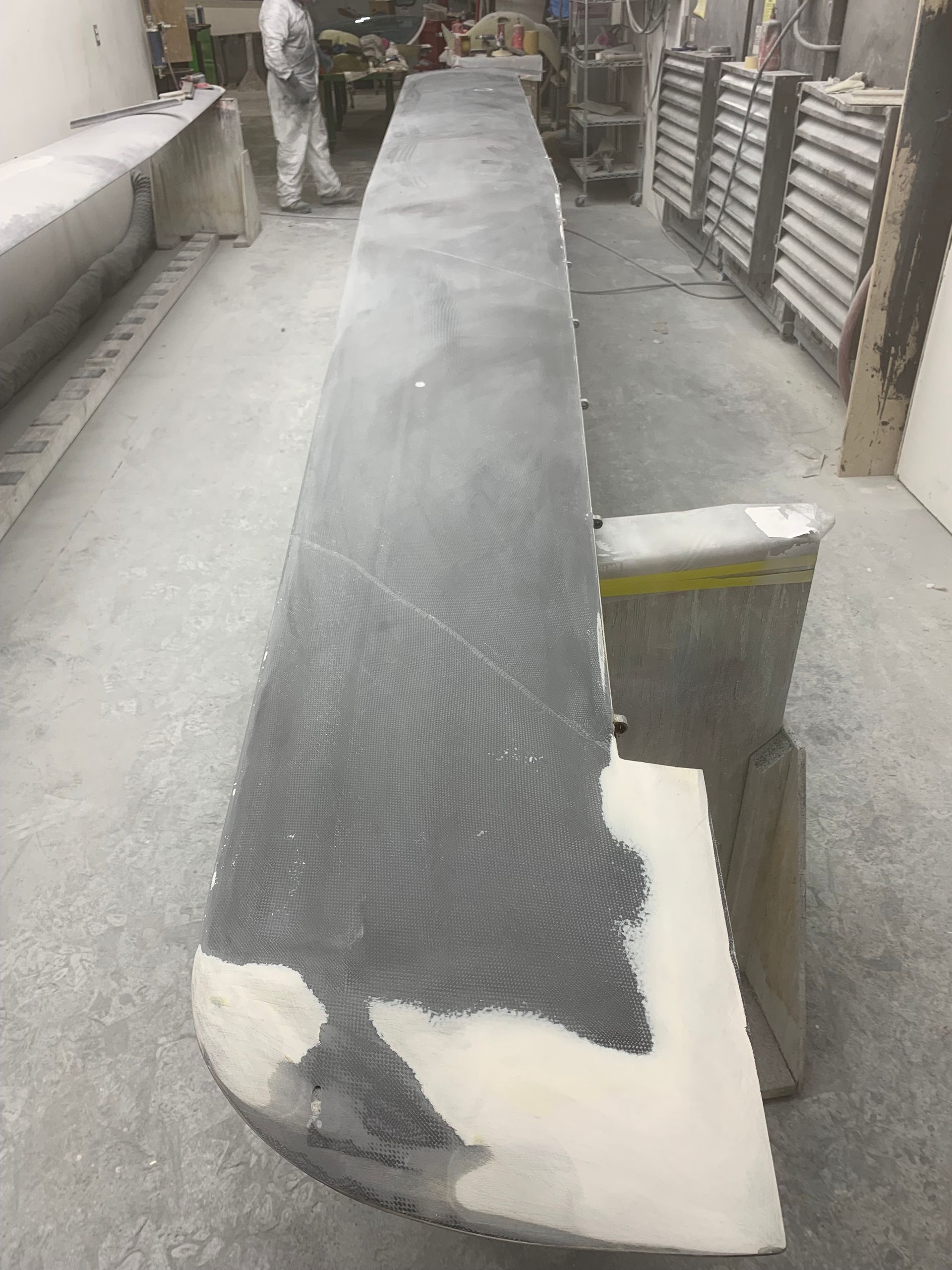 A long piece of wood is sitting on the floor in a room.