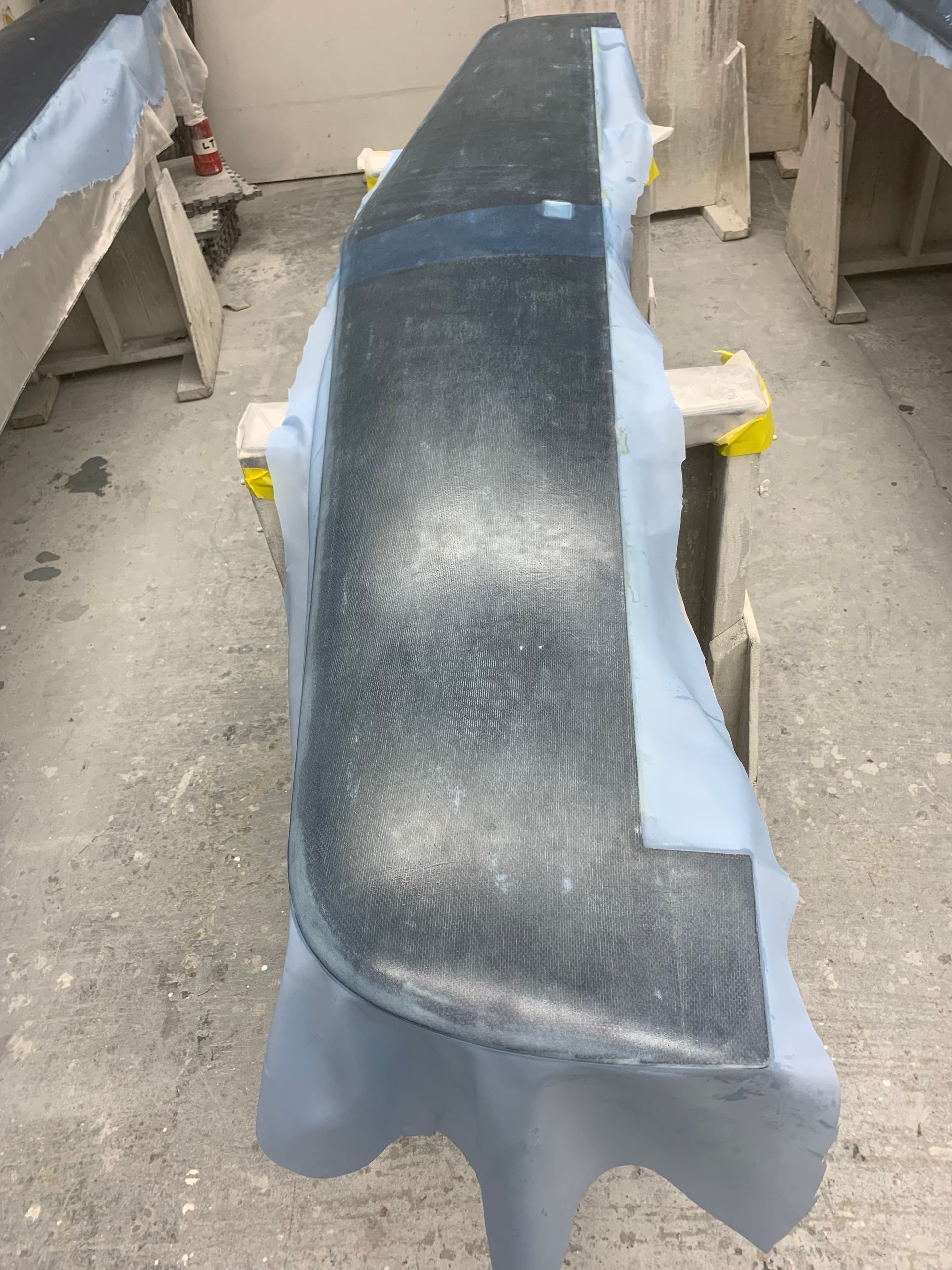 A piece of metal is sitting on top of a blue cloth on a table.