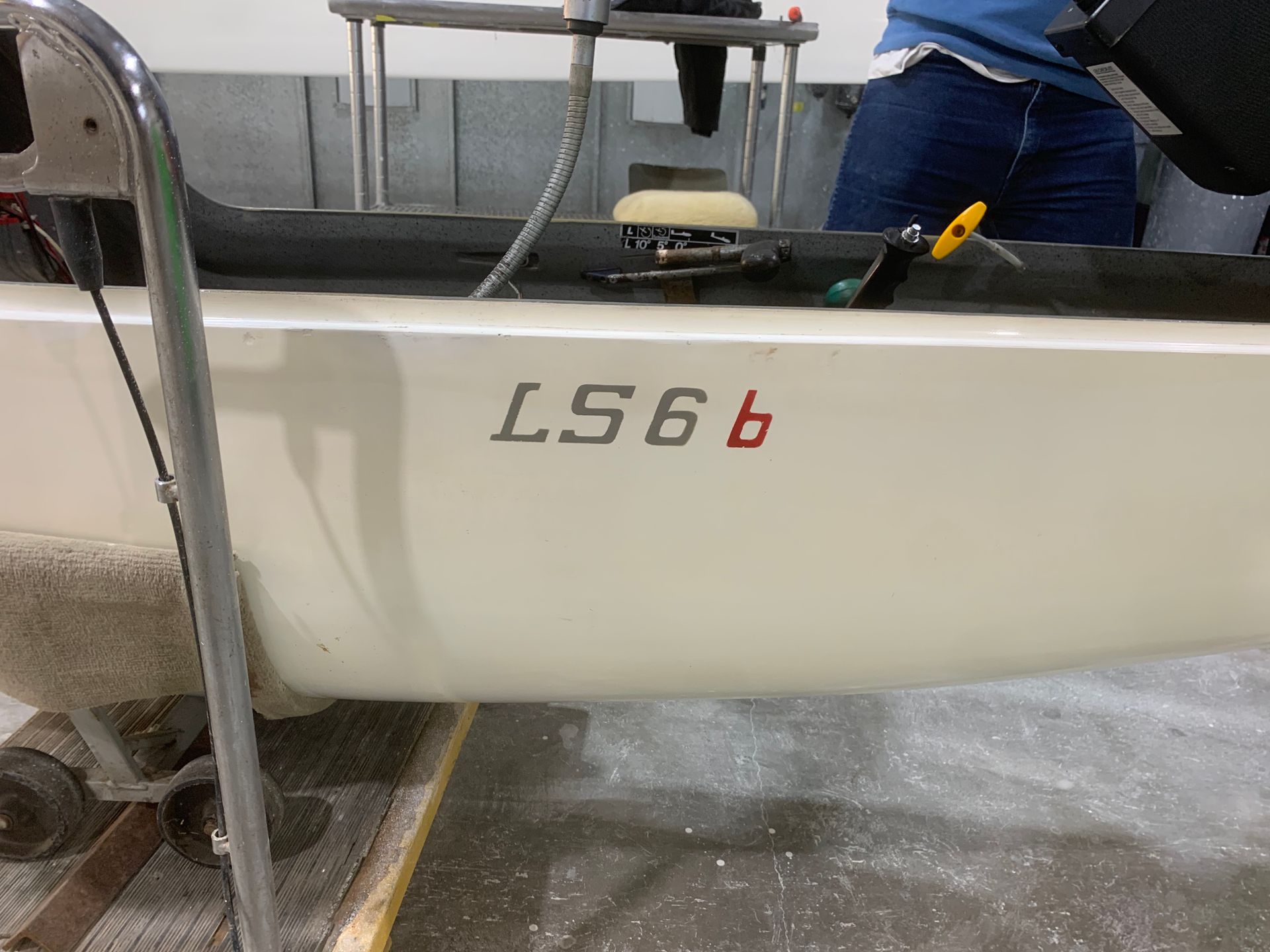 A white boat with the number ls66 on the side