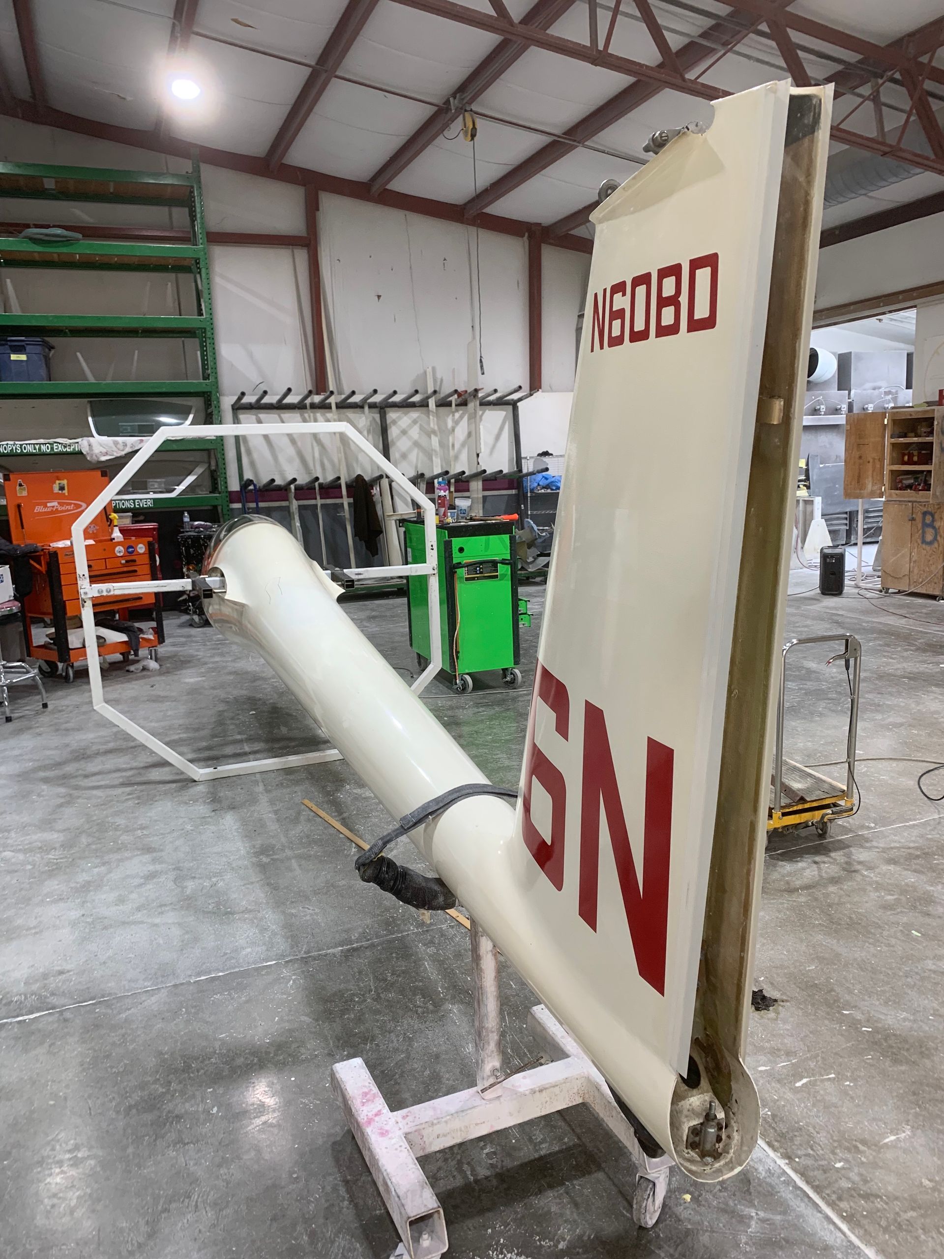 A piece of airplane wing with gn written on it