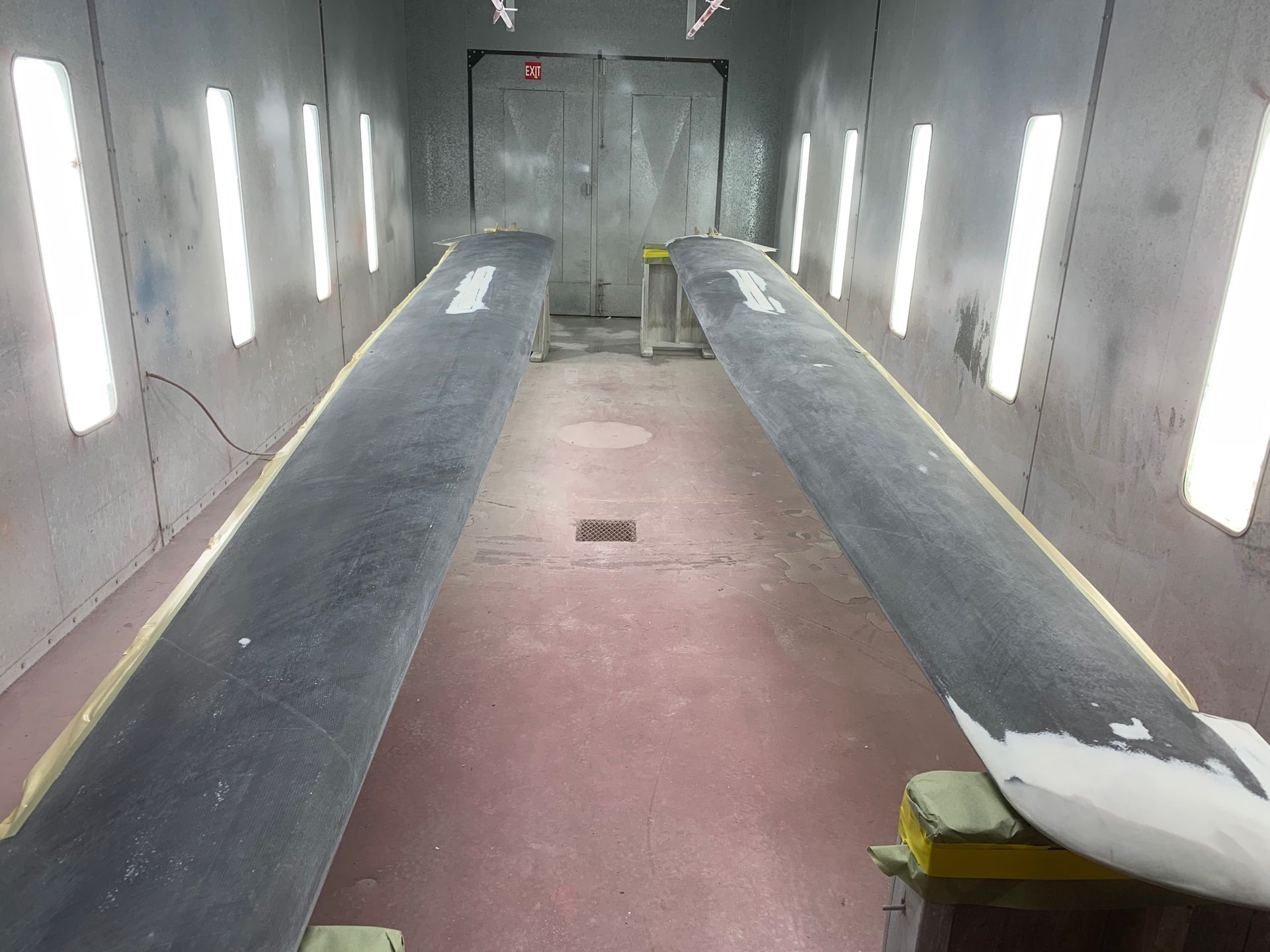 A long narrow room with a lot of lights on the walls