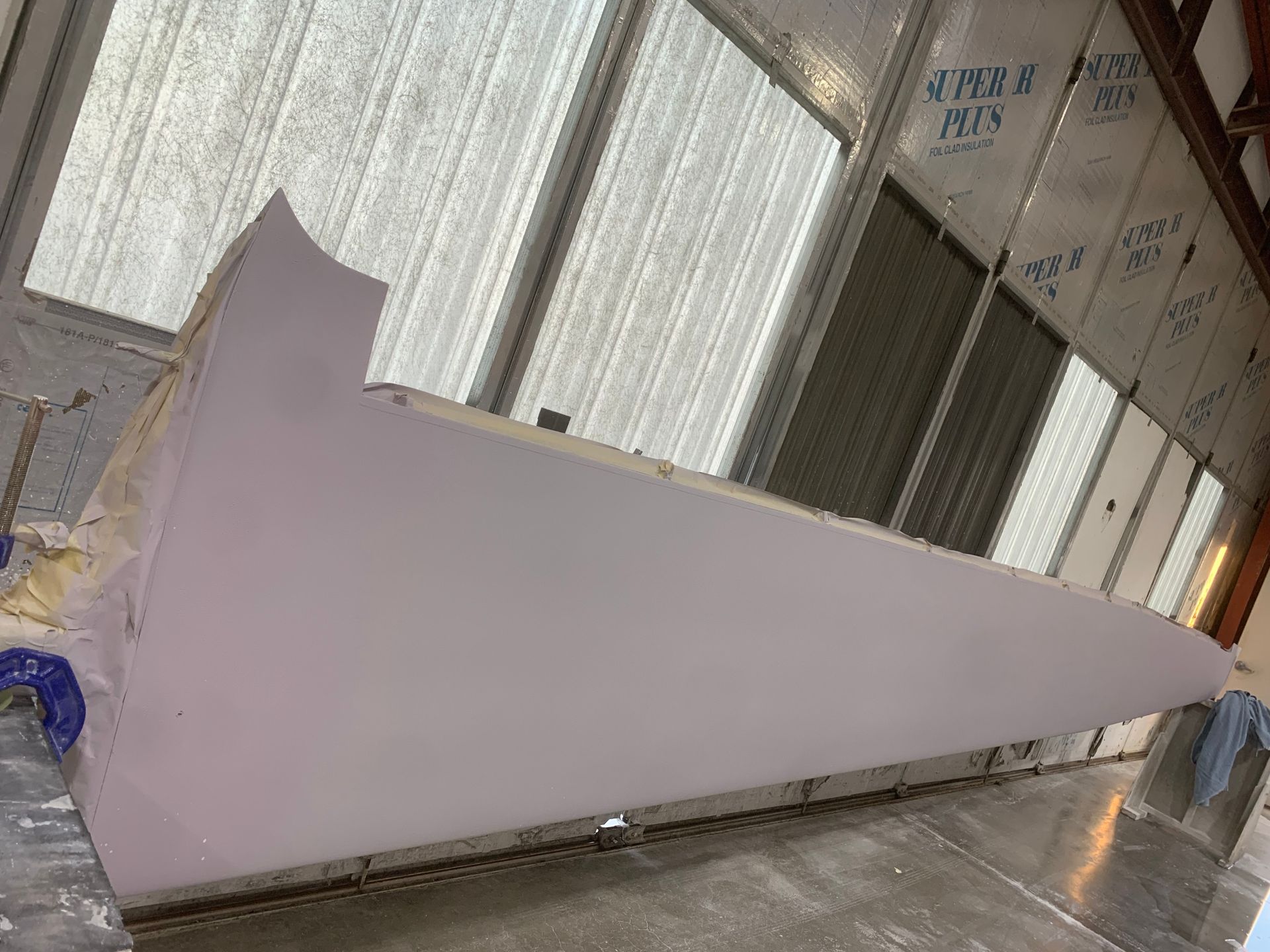 A large piece of white foam is sitting on the floor in a room.