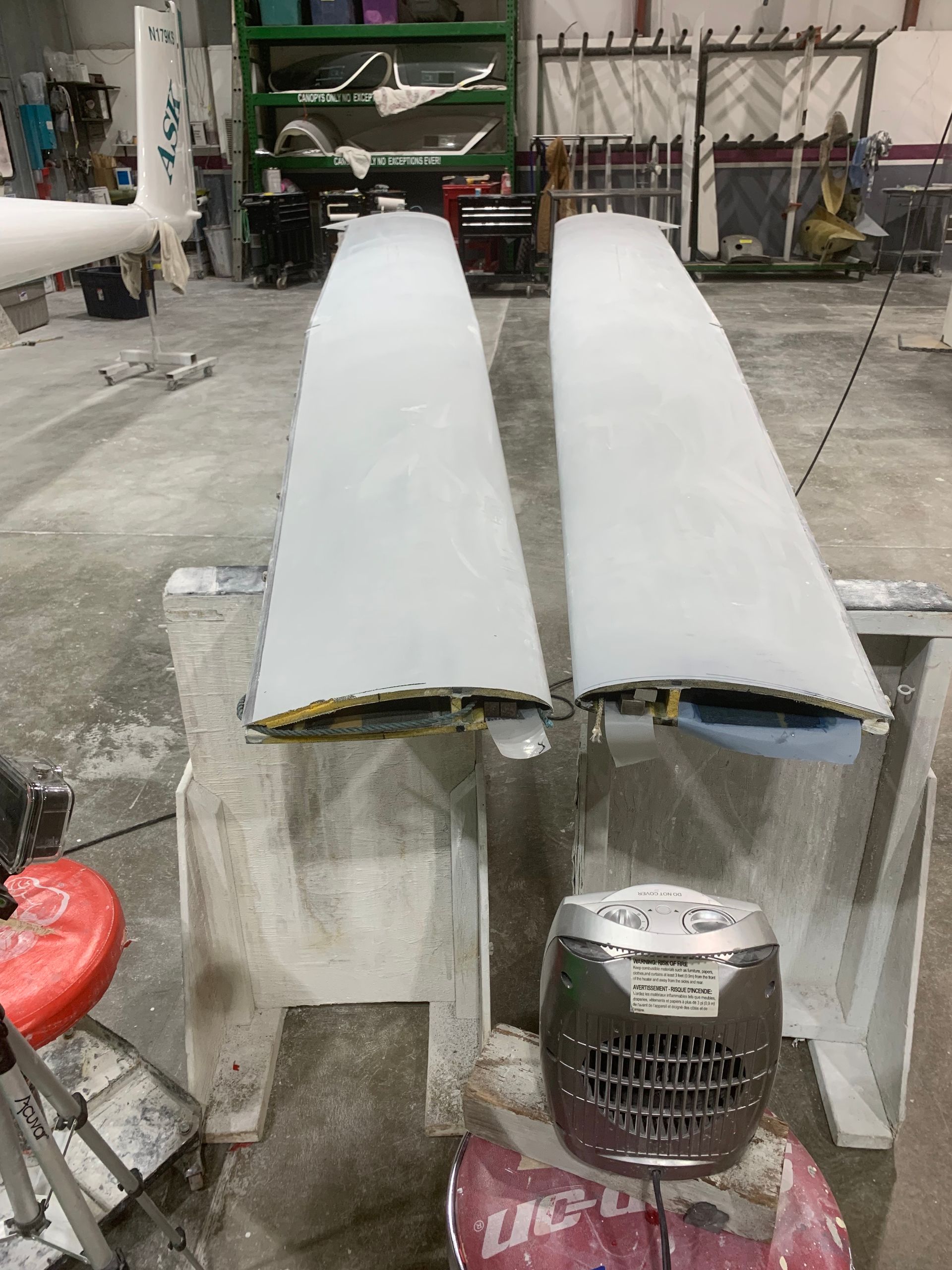 A pair of wings are sitting on a table in a garage.