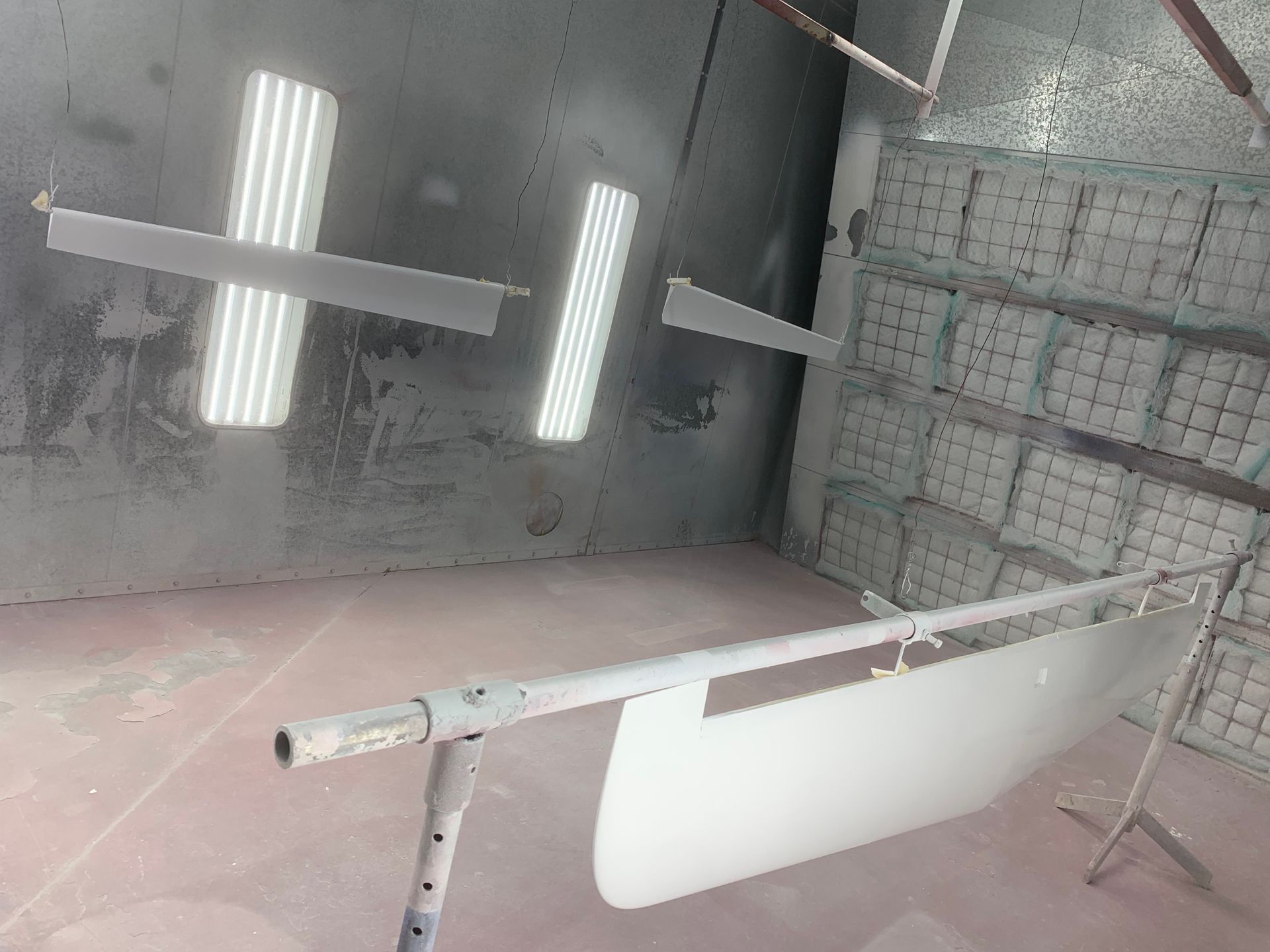 A room with a lot of lights hanging from the ceiling