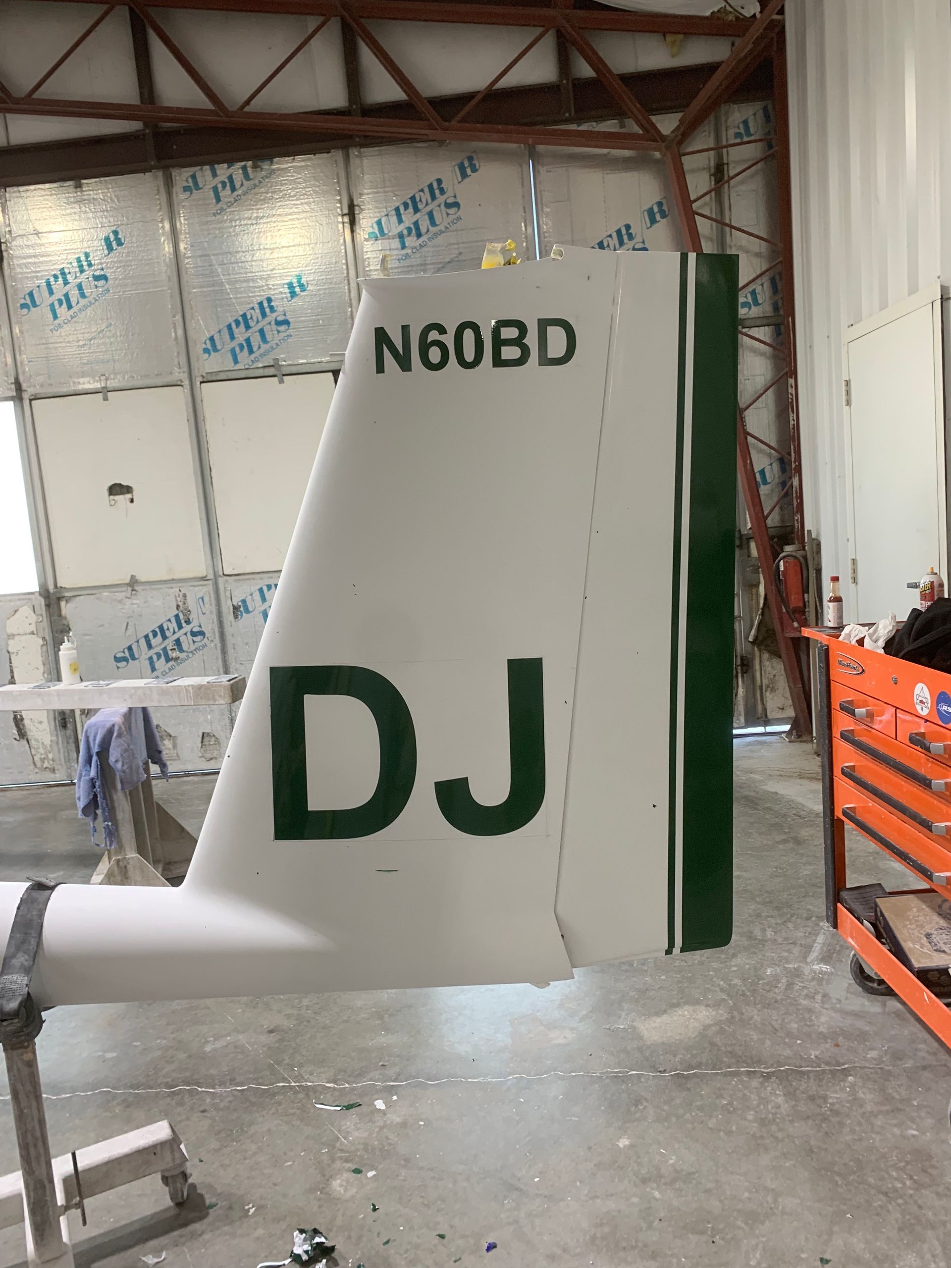 A plane wing with the letters dj on it