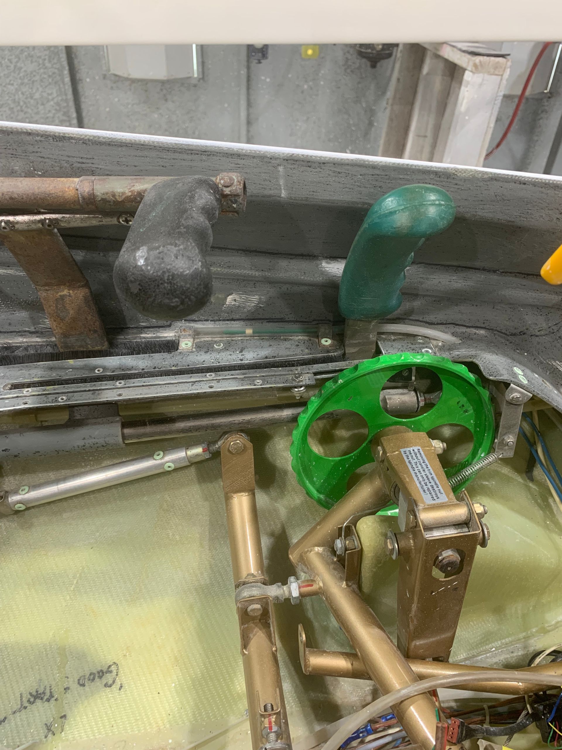 A green wheel is sitting on top of a metal structure.