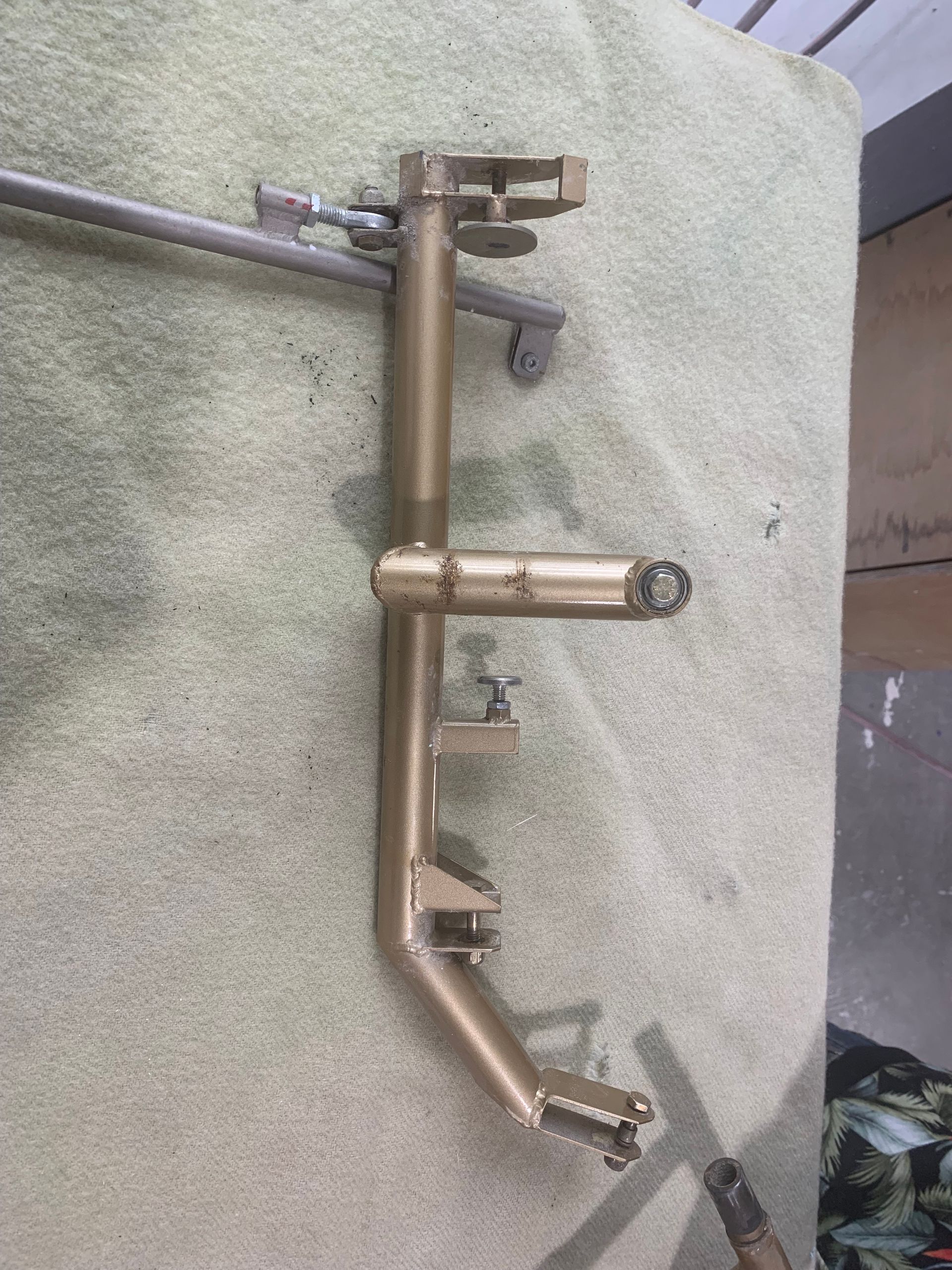 A metal pipe is sitting on top of a towel on a table.