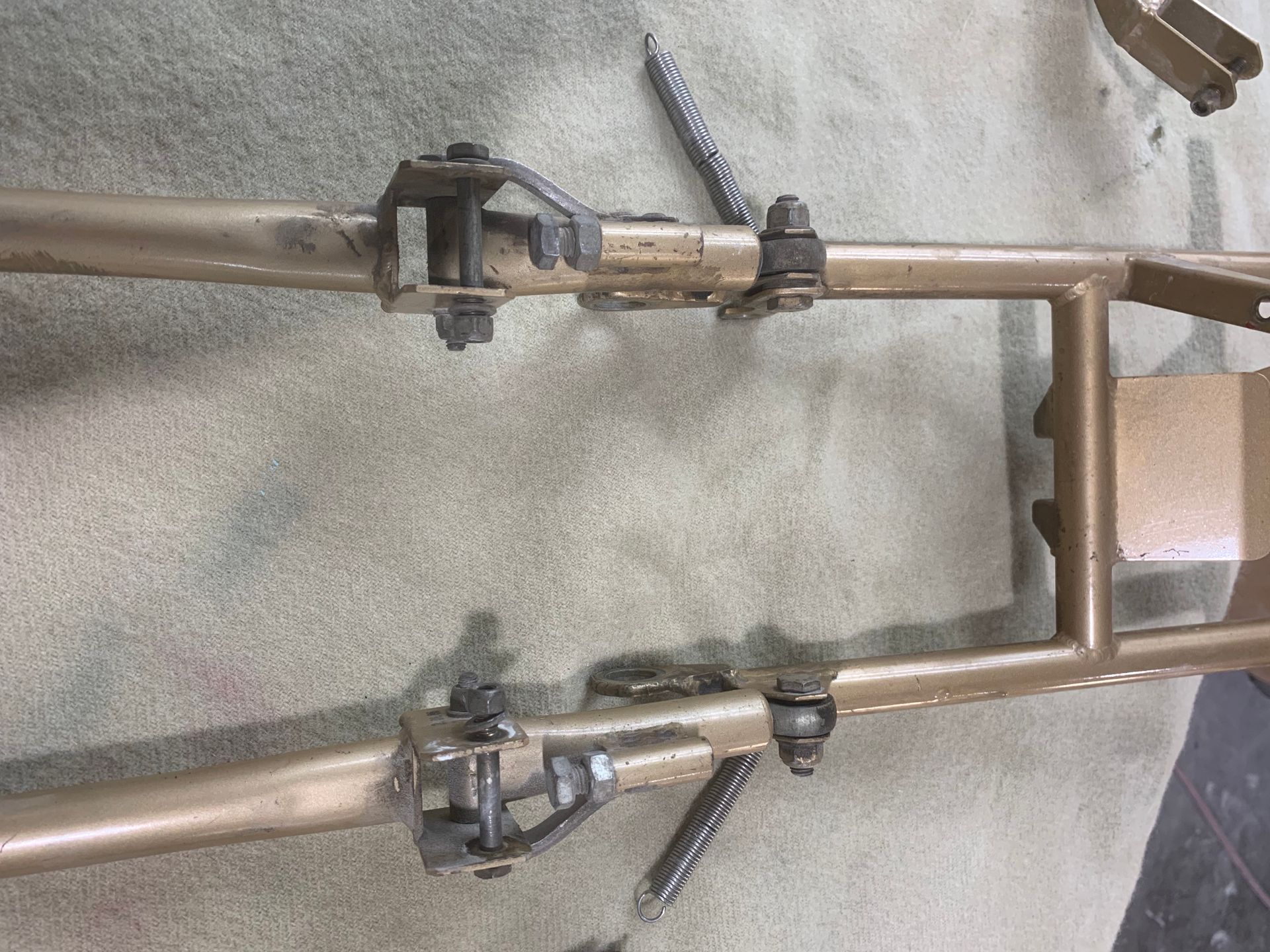 A close up of a metal frame on a concrete surface.