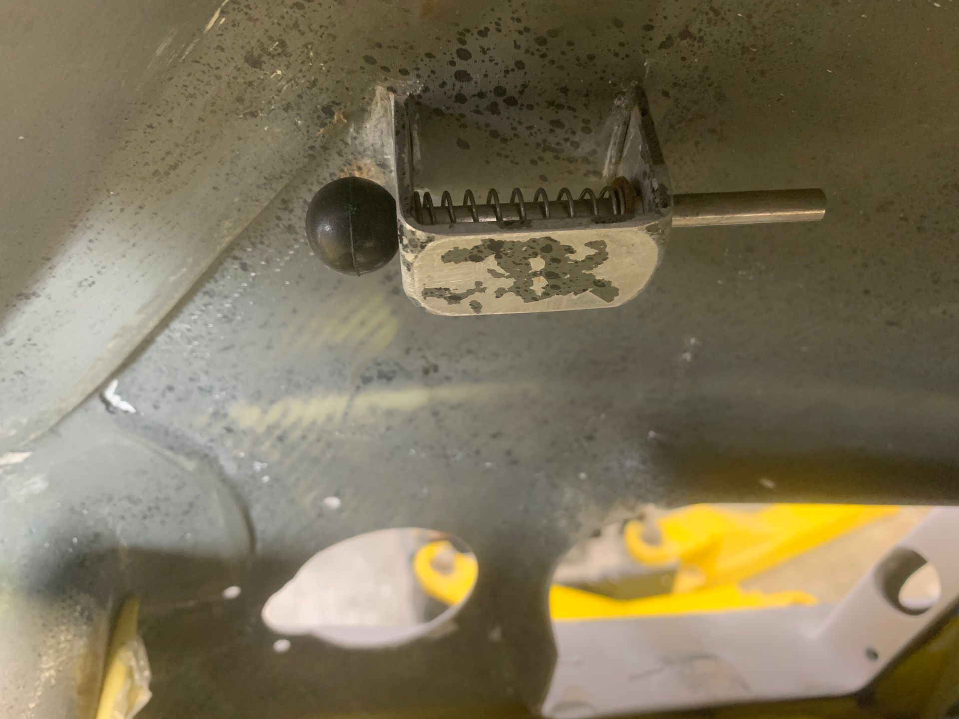 A close up of a metal object with a ball on top of it.