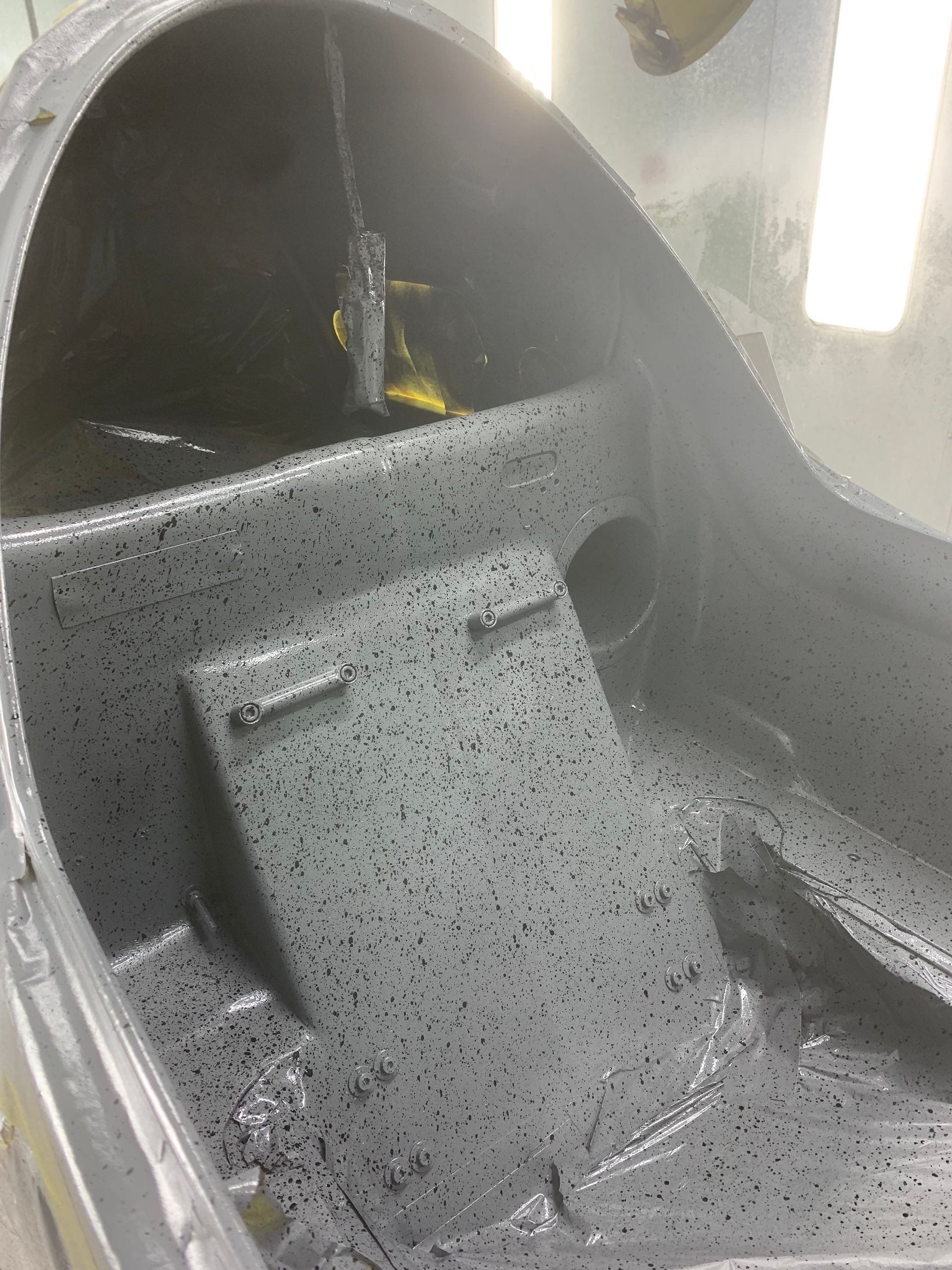The inside of a boat is covered in gray paint.