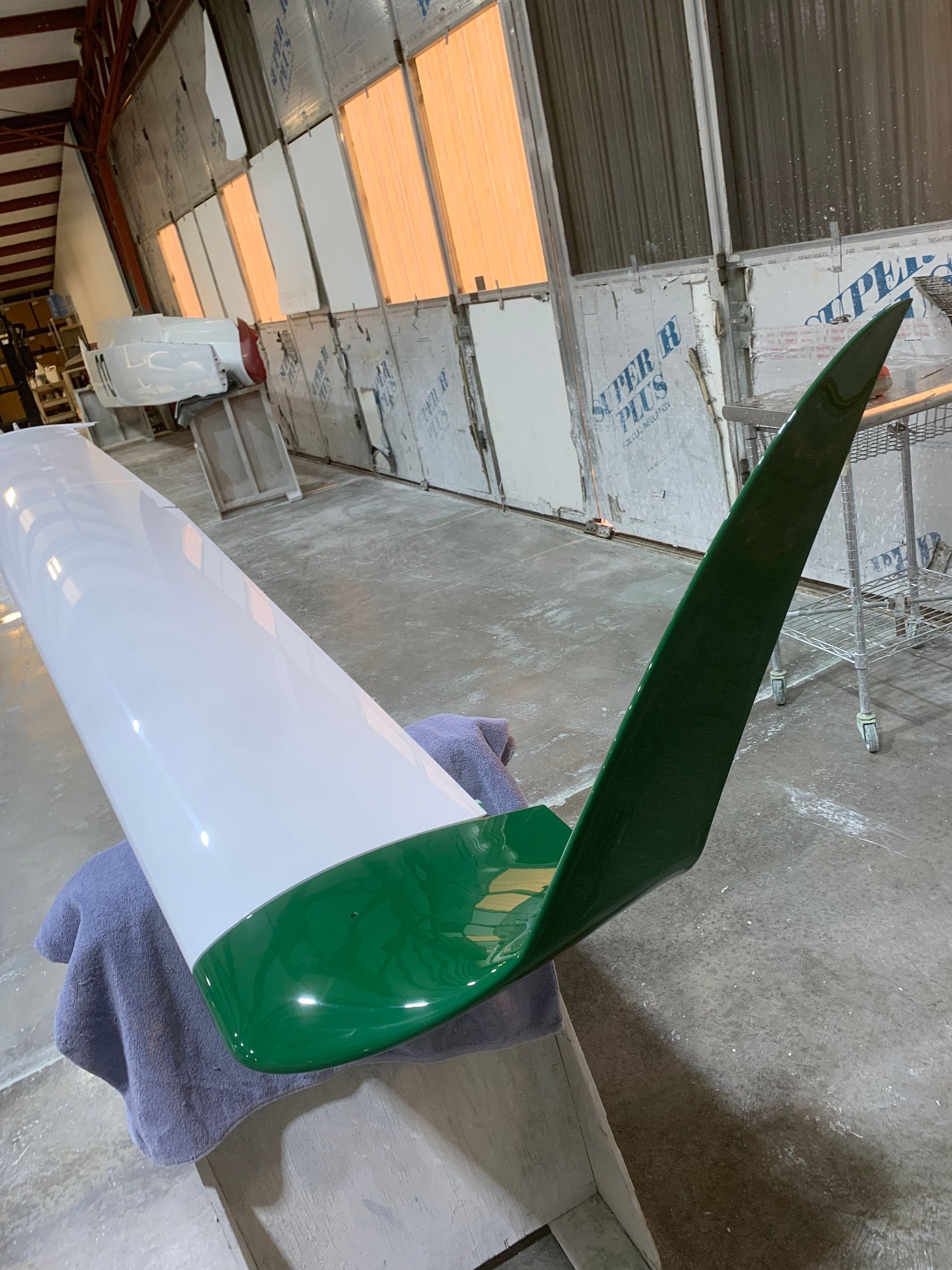 A green and white object is sitting on the floor in a room.