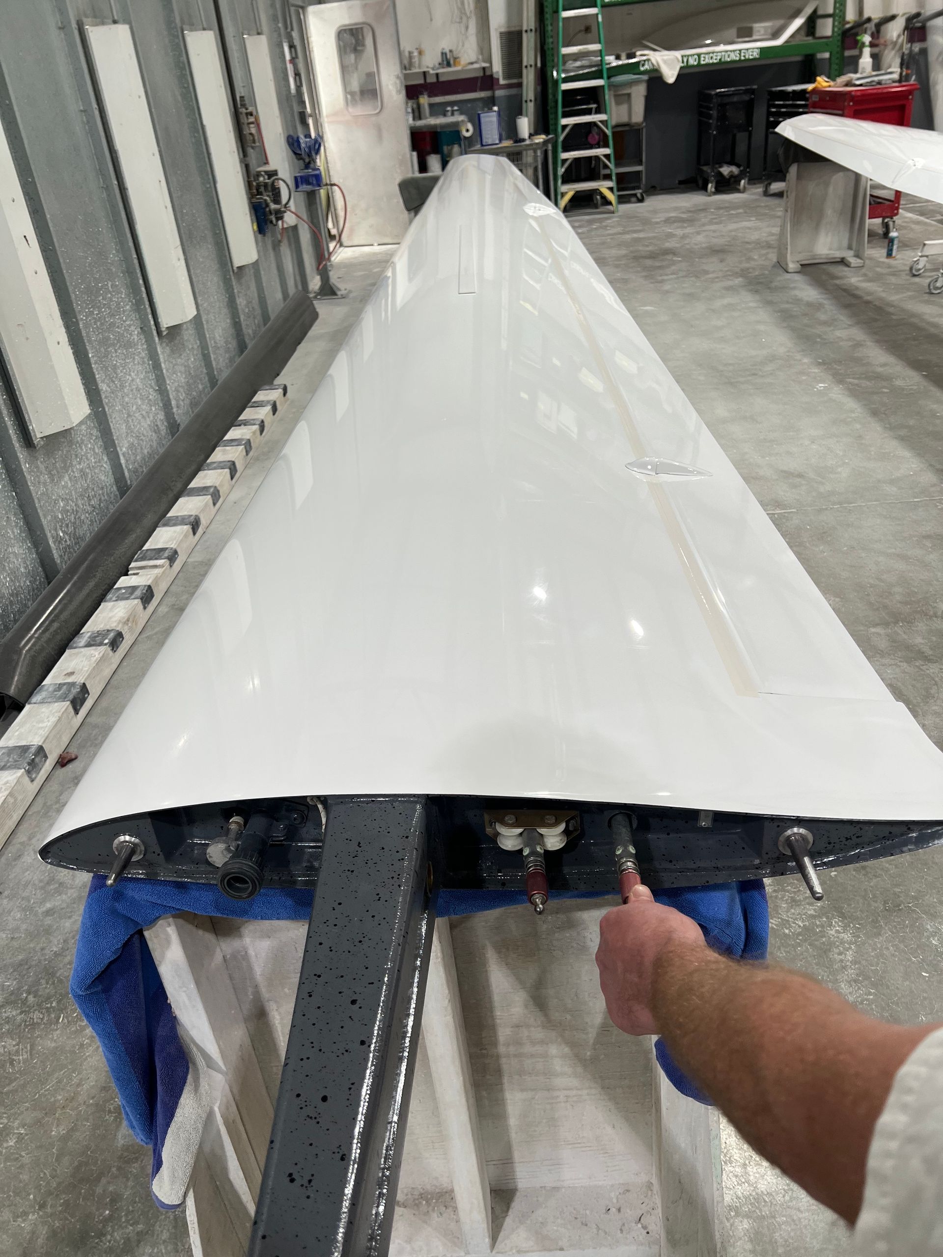 A person is holding a large white object in a room.