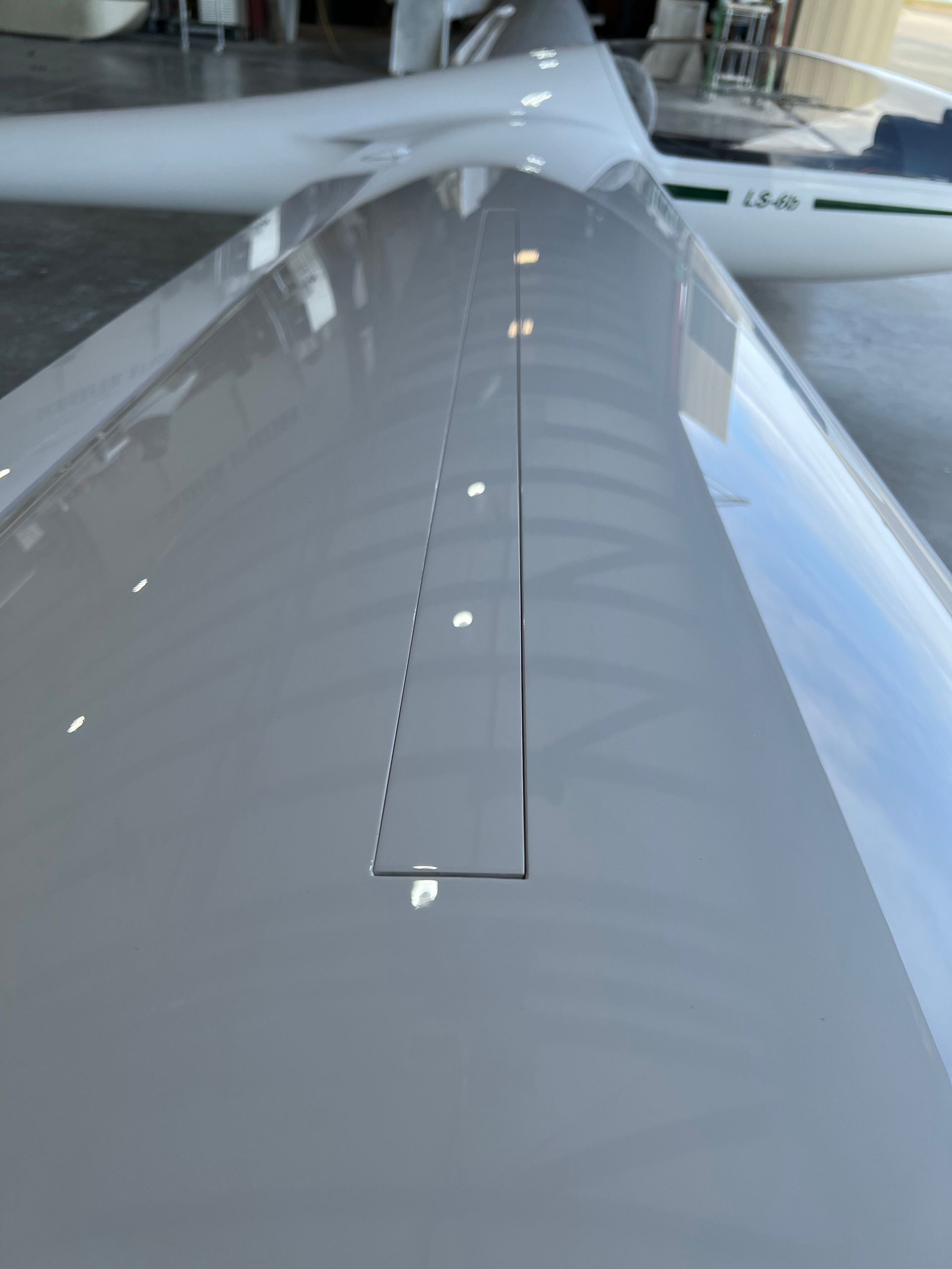 A close up of a plane 's wing in a hangar.