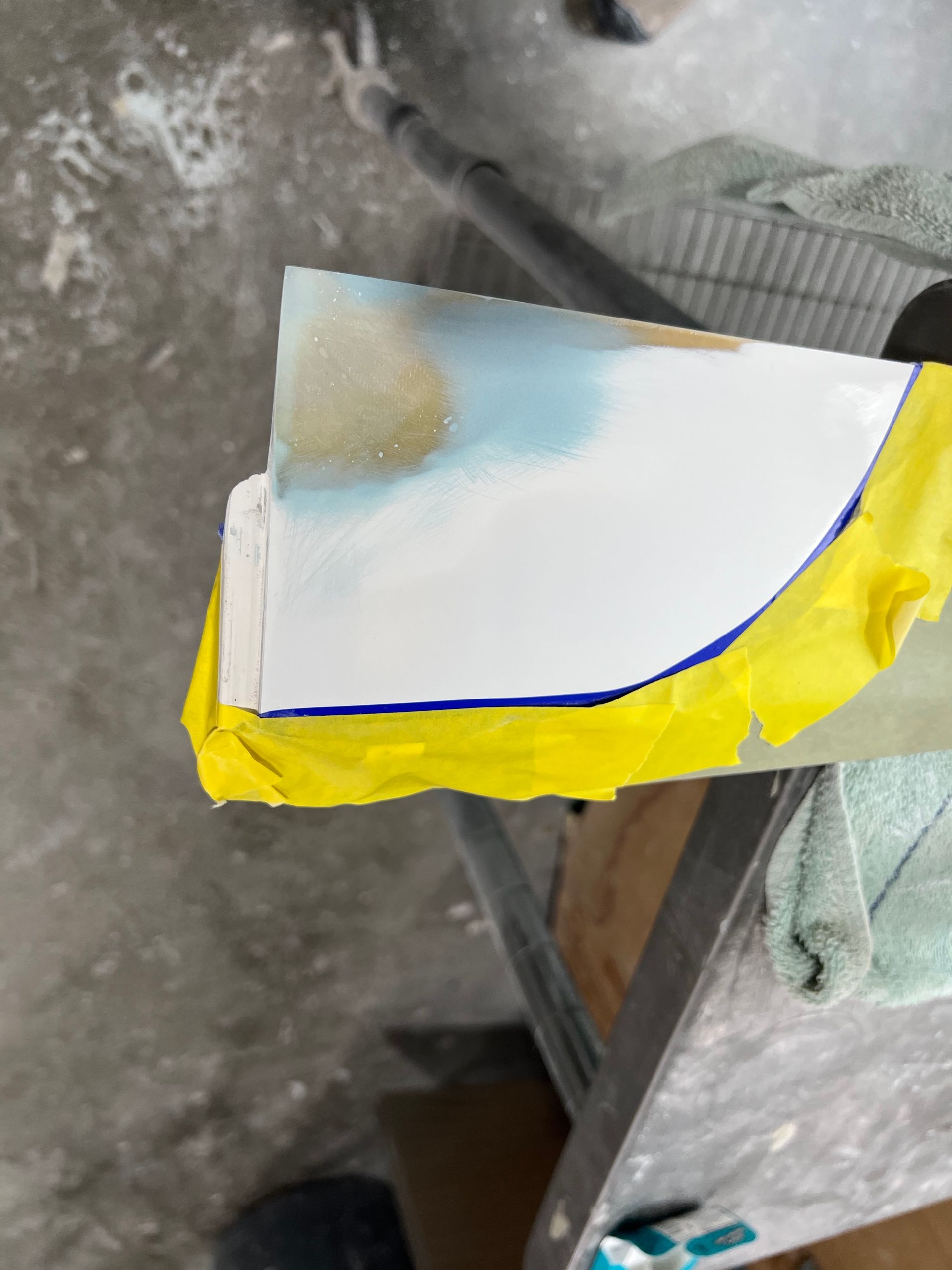 A piece of paper with yellow tape on it is sitting on a table.