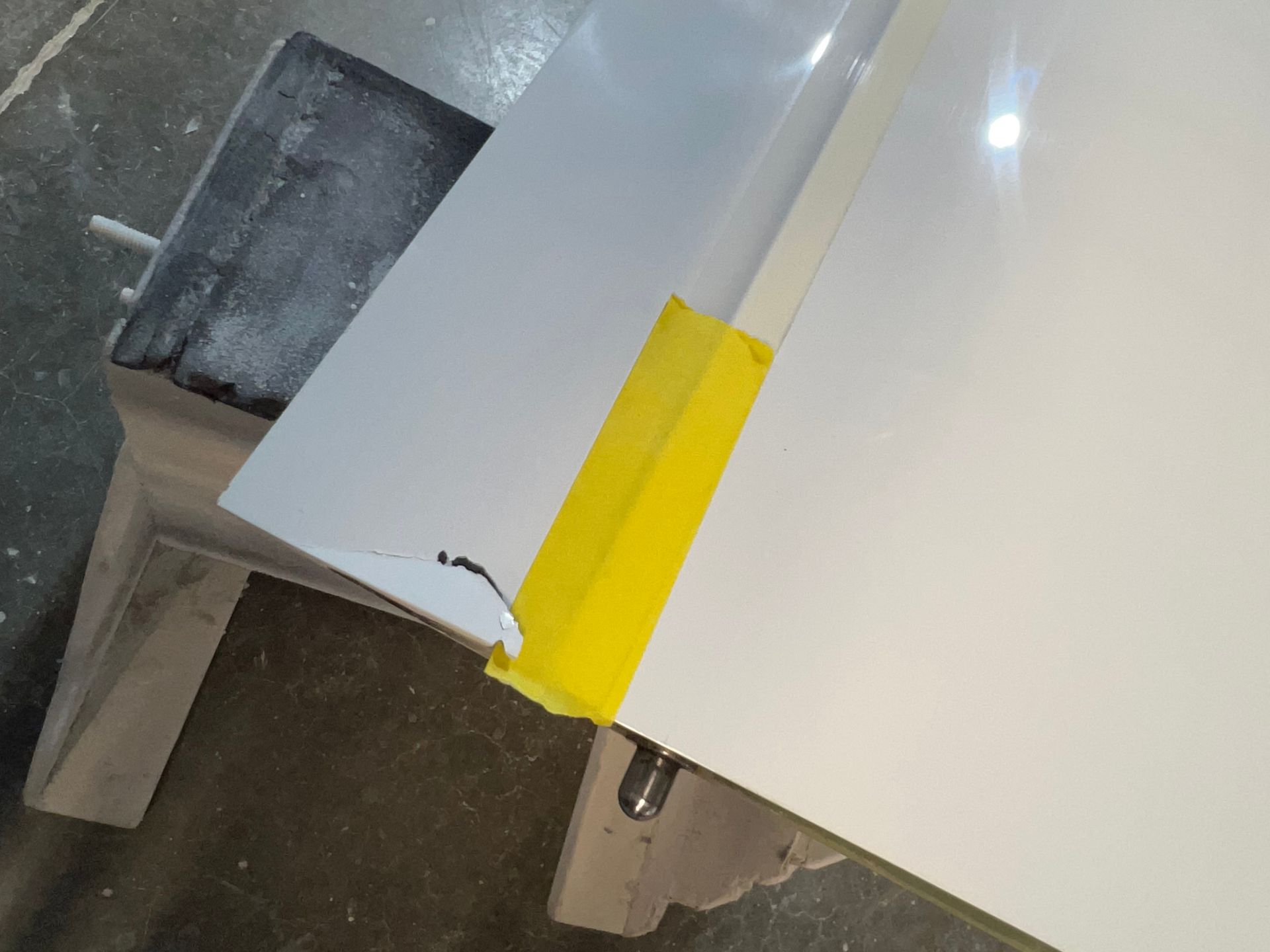 A piece of paper with a yellow tape on it