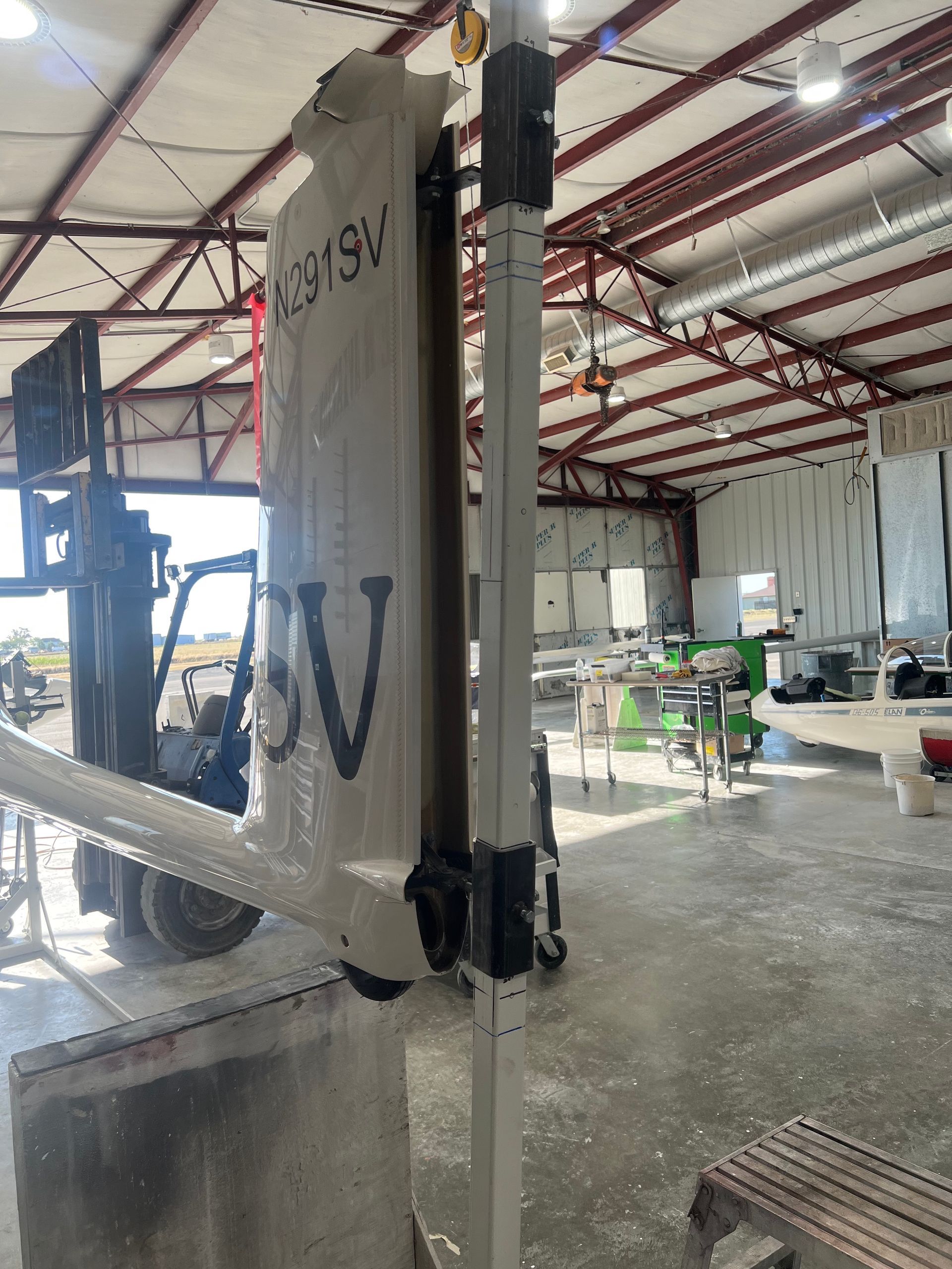 A building with a forklift and a sign that says wv on it