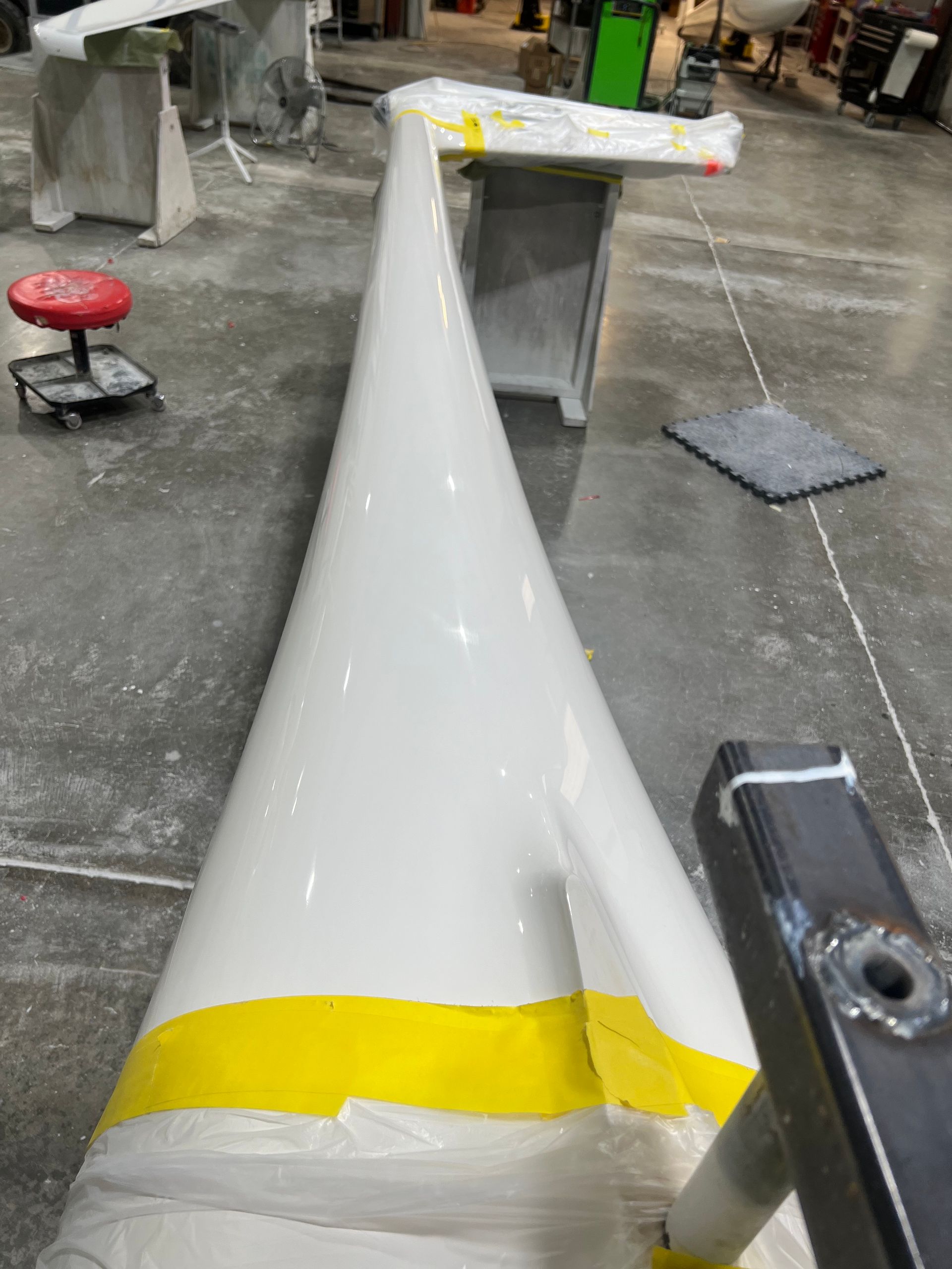 A white cone with a yellow stripe on it