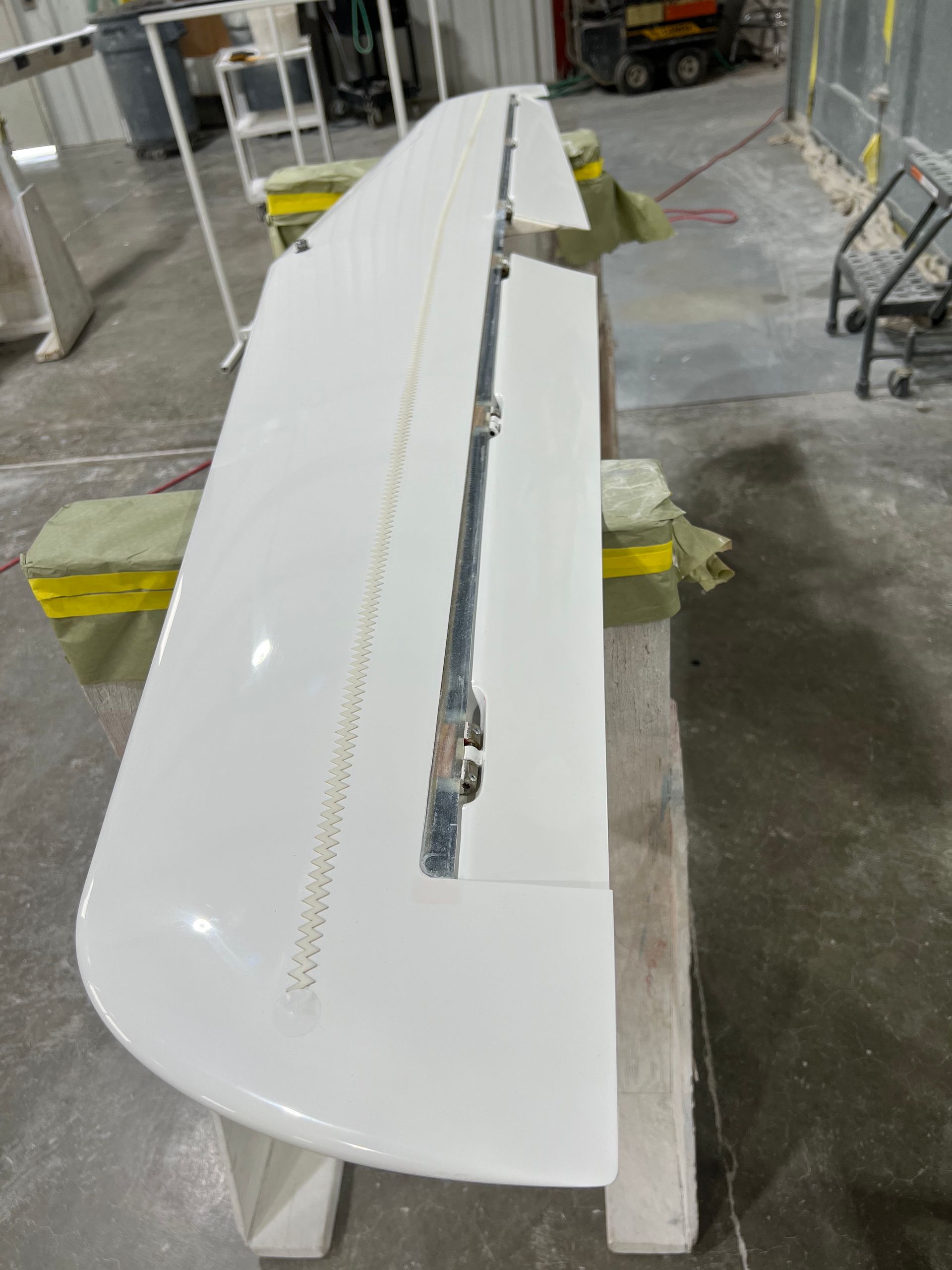 A white wing is sitting on top of a concrete table.
