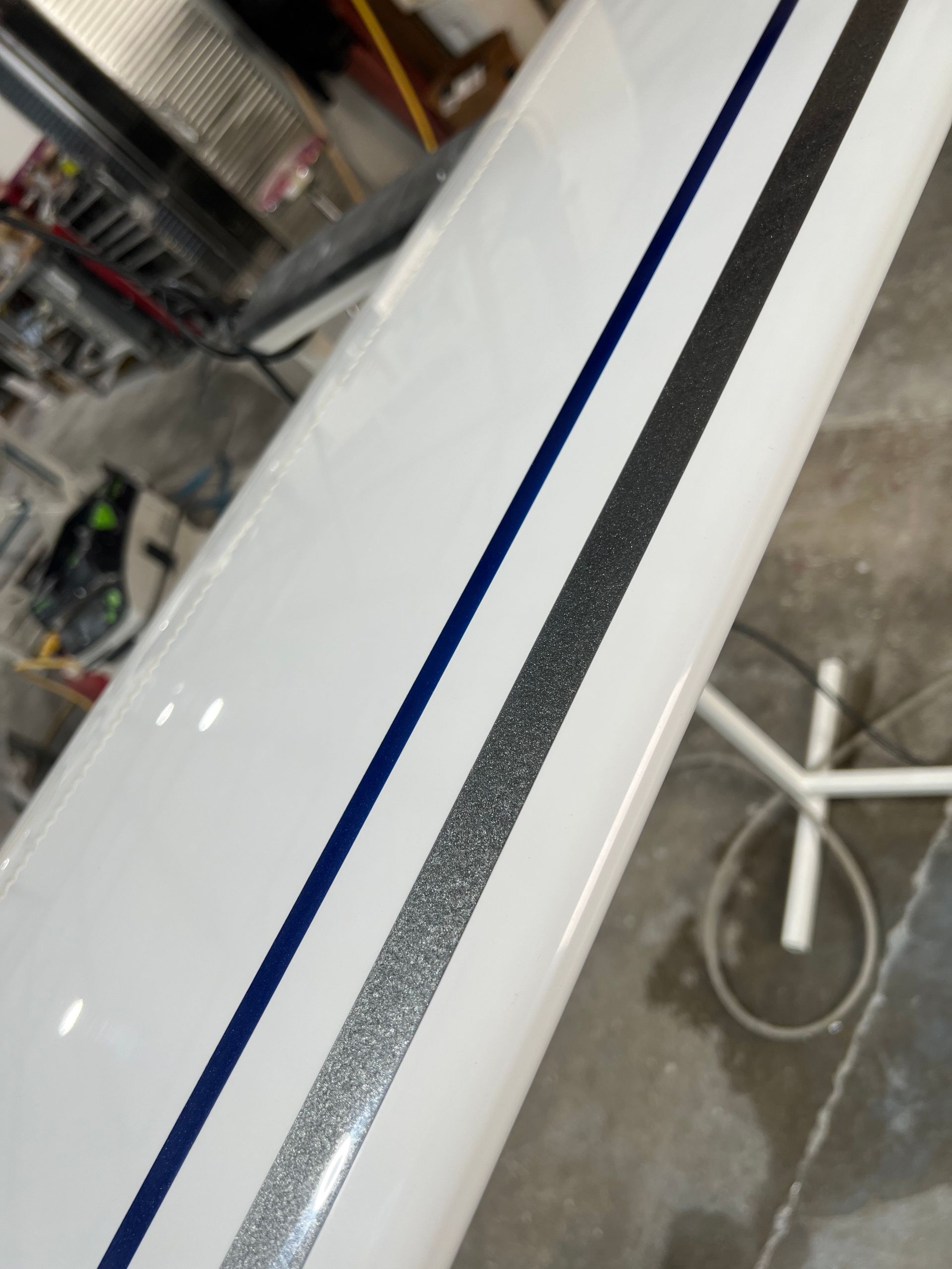 A white object with a blue and silver stripe on it