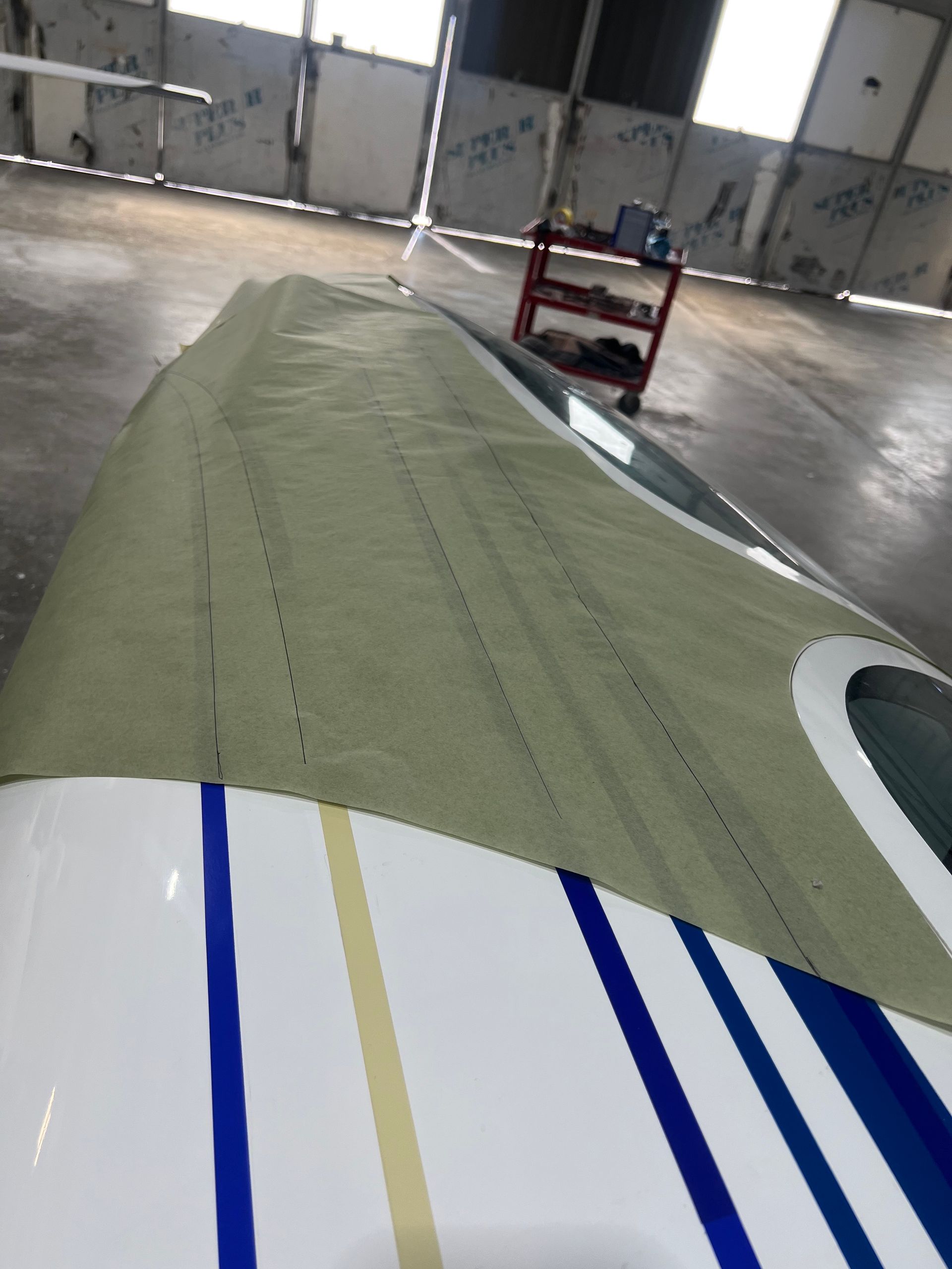 A white boat with blue and yellow stripes on it