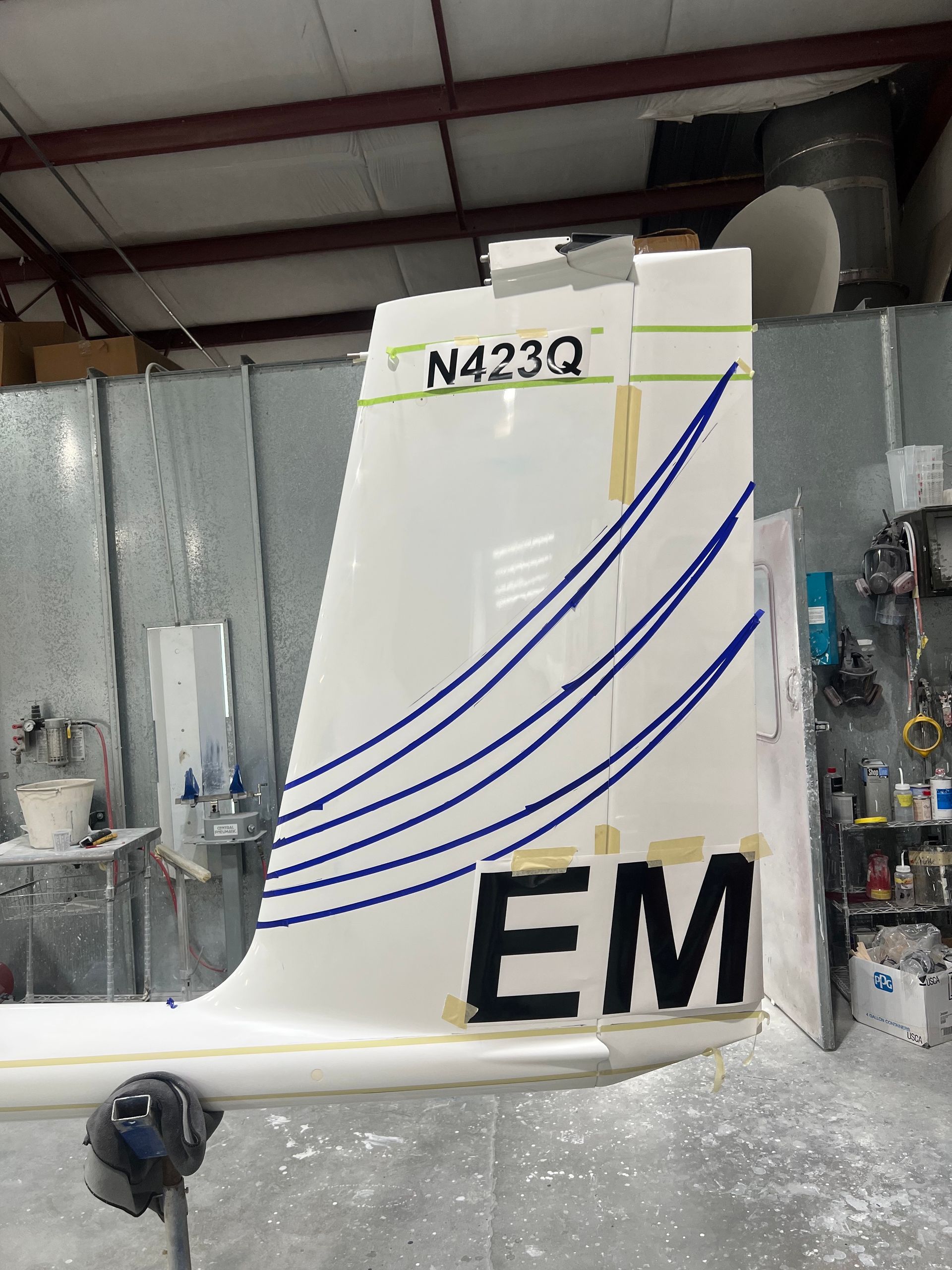 The tail of a plane with em written on it