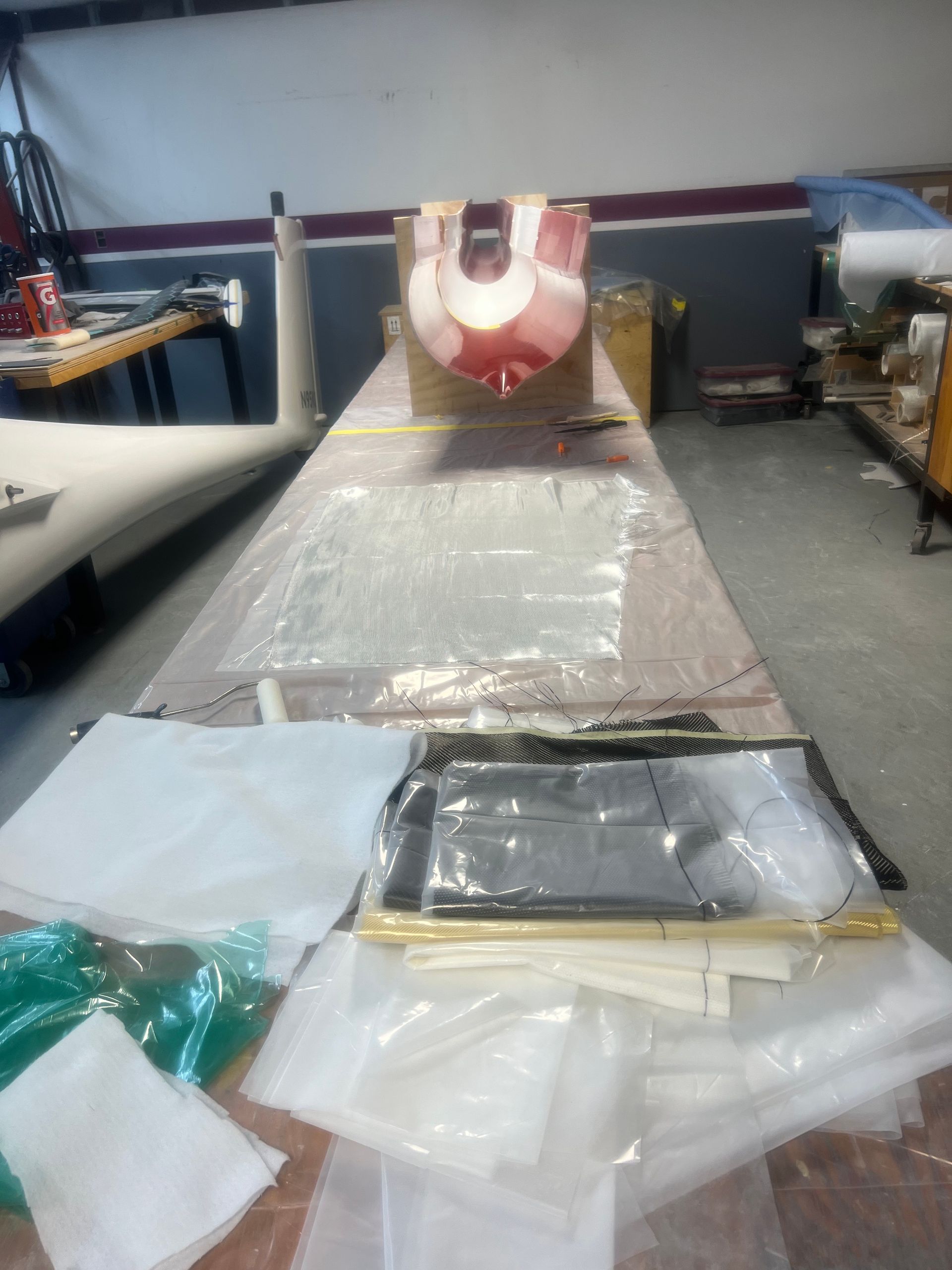 A boat is sitting on top of a table in a garage.