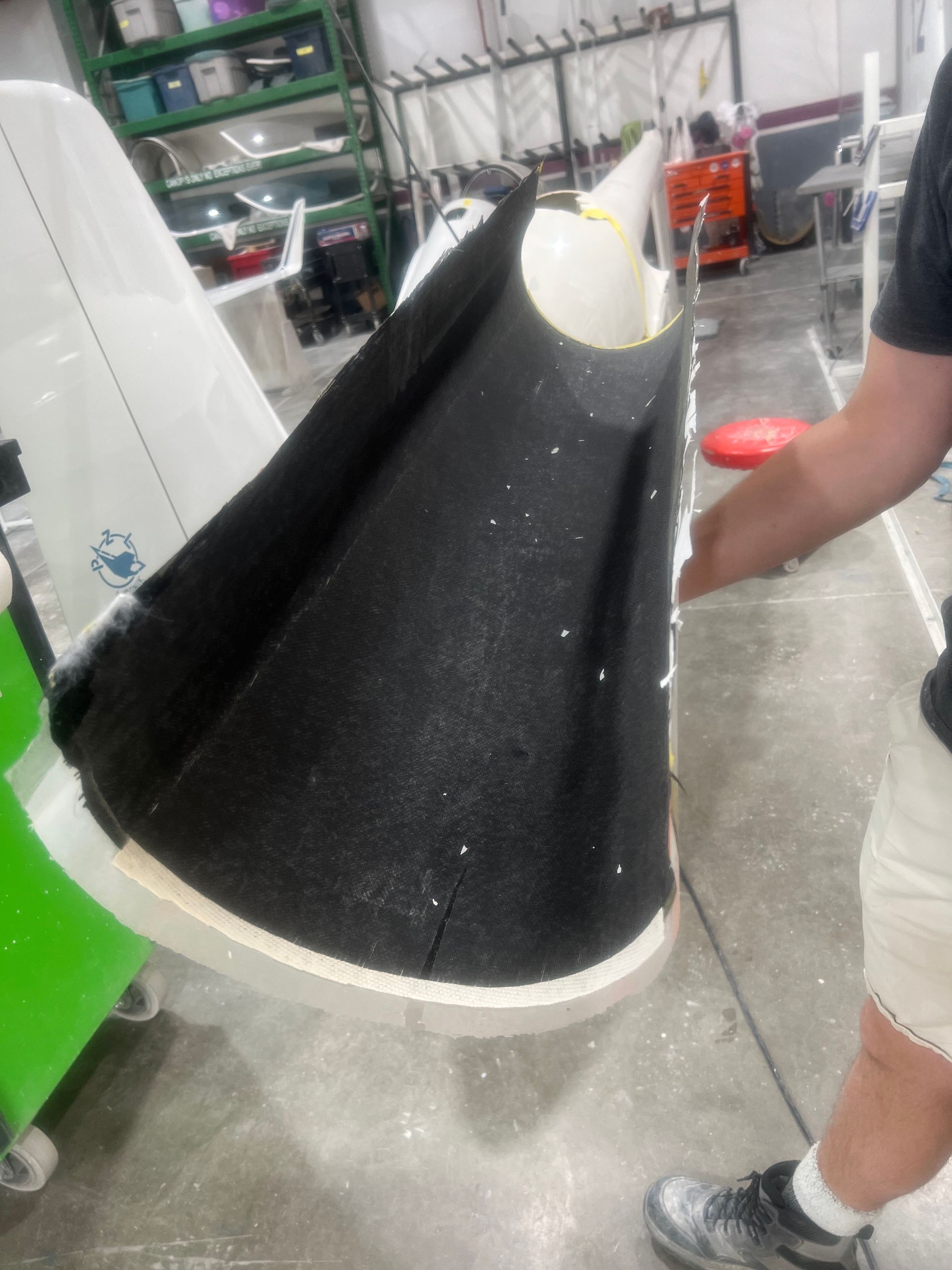 A man is holding a piece of black foam in his hands.