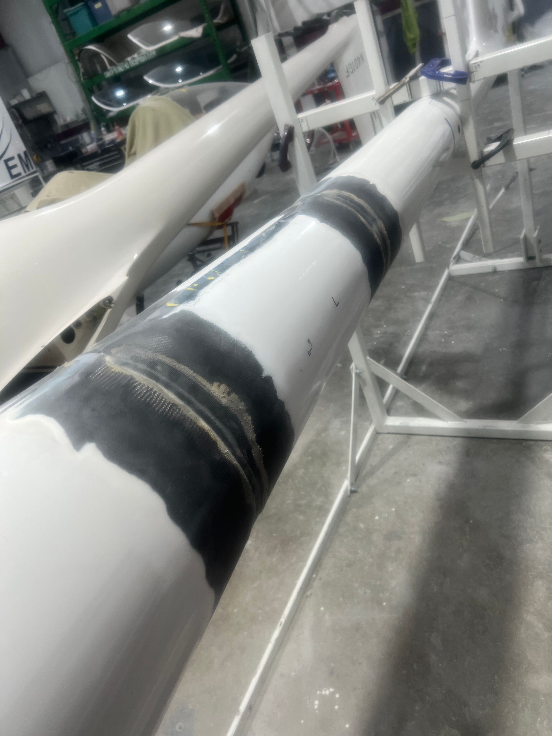 A white pipe with a black stripe on it