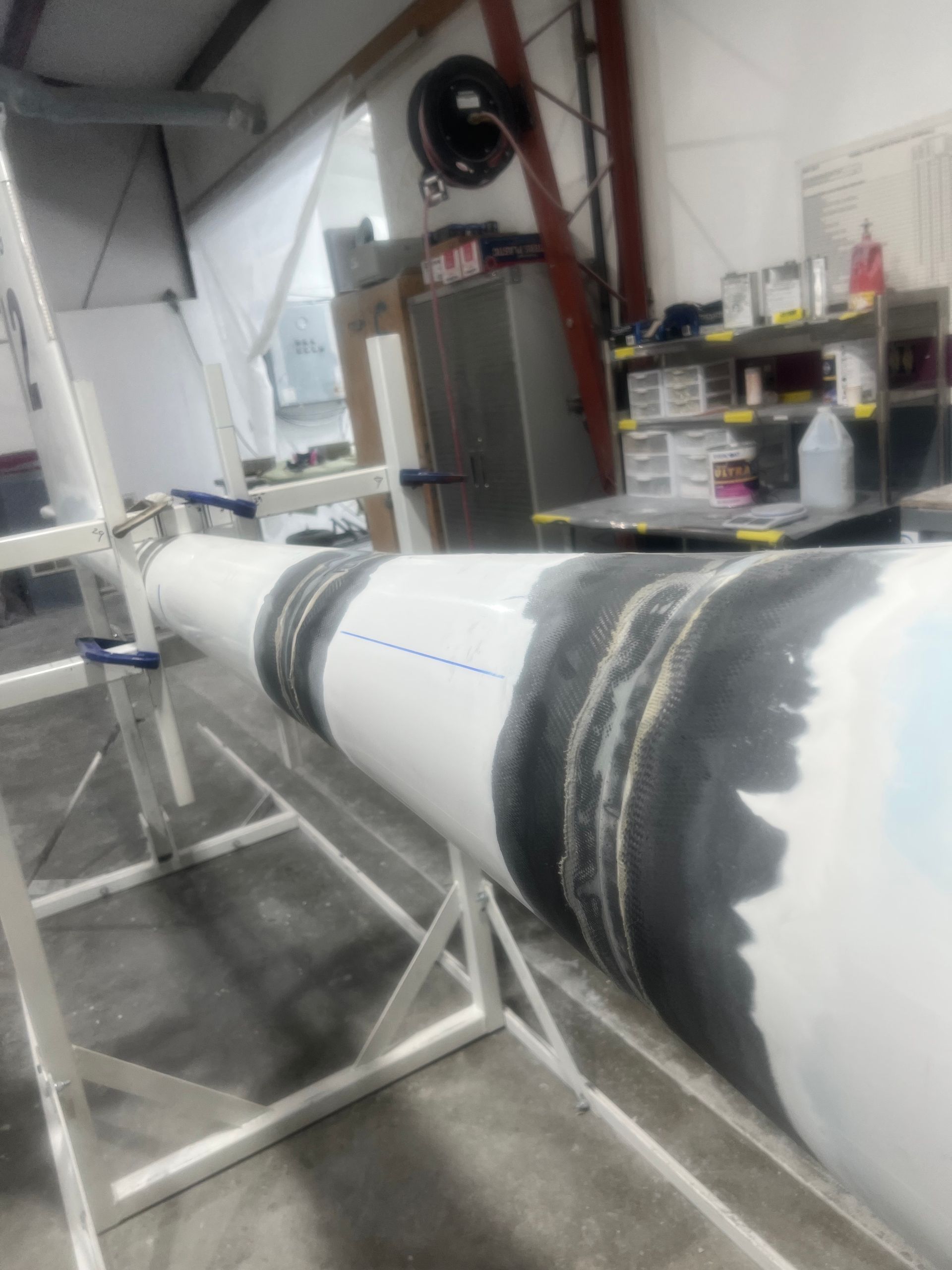 A large white pipe is sitting on a stand in a room