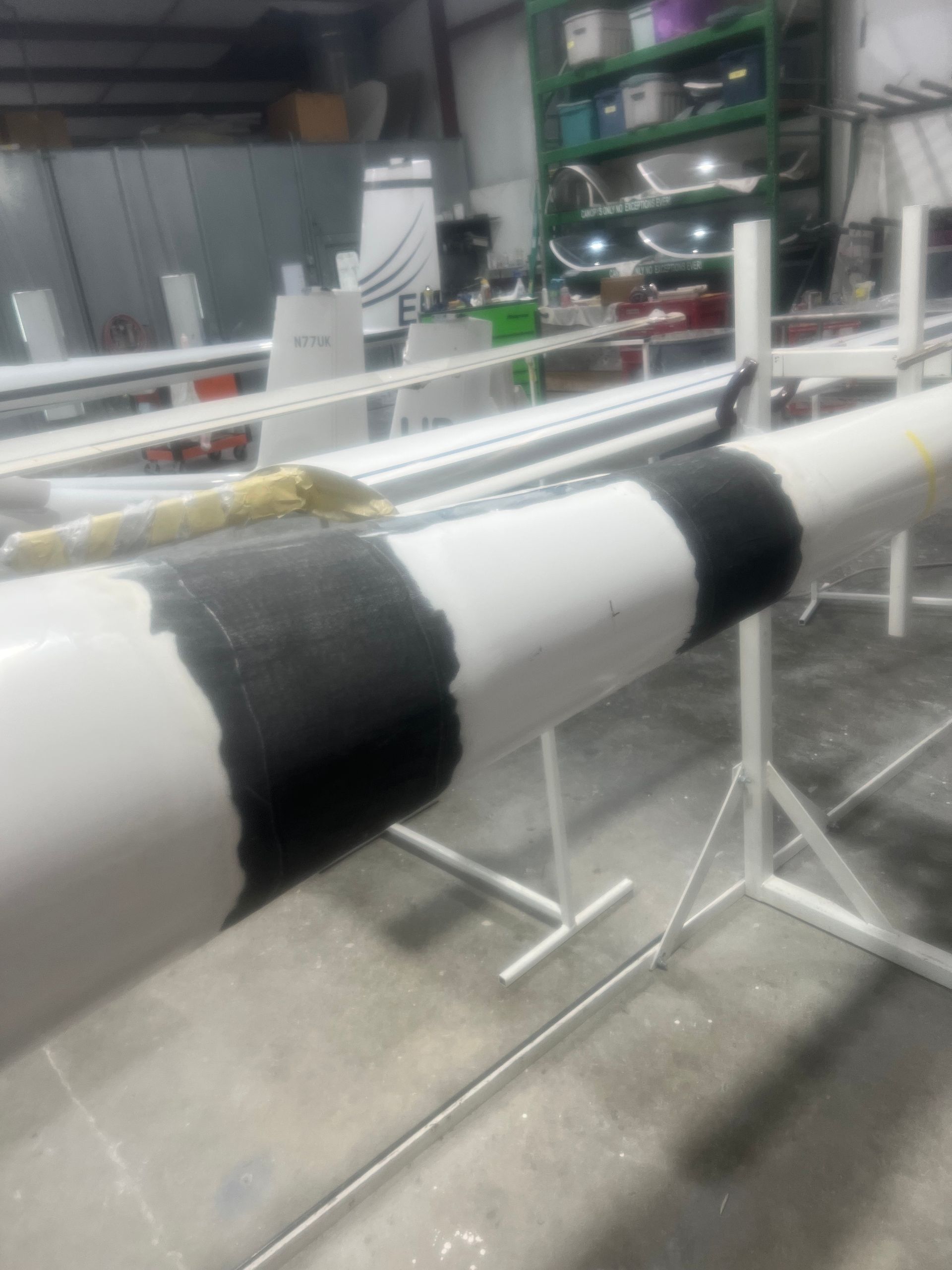 A black and white pipe is sitting on a stand in a room.