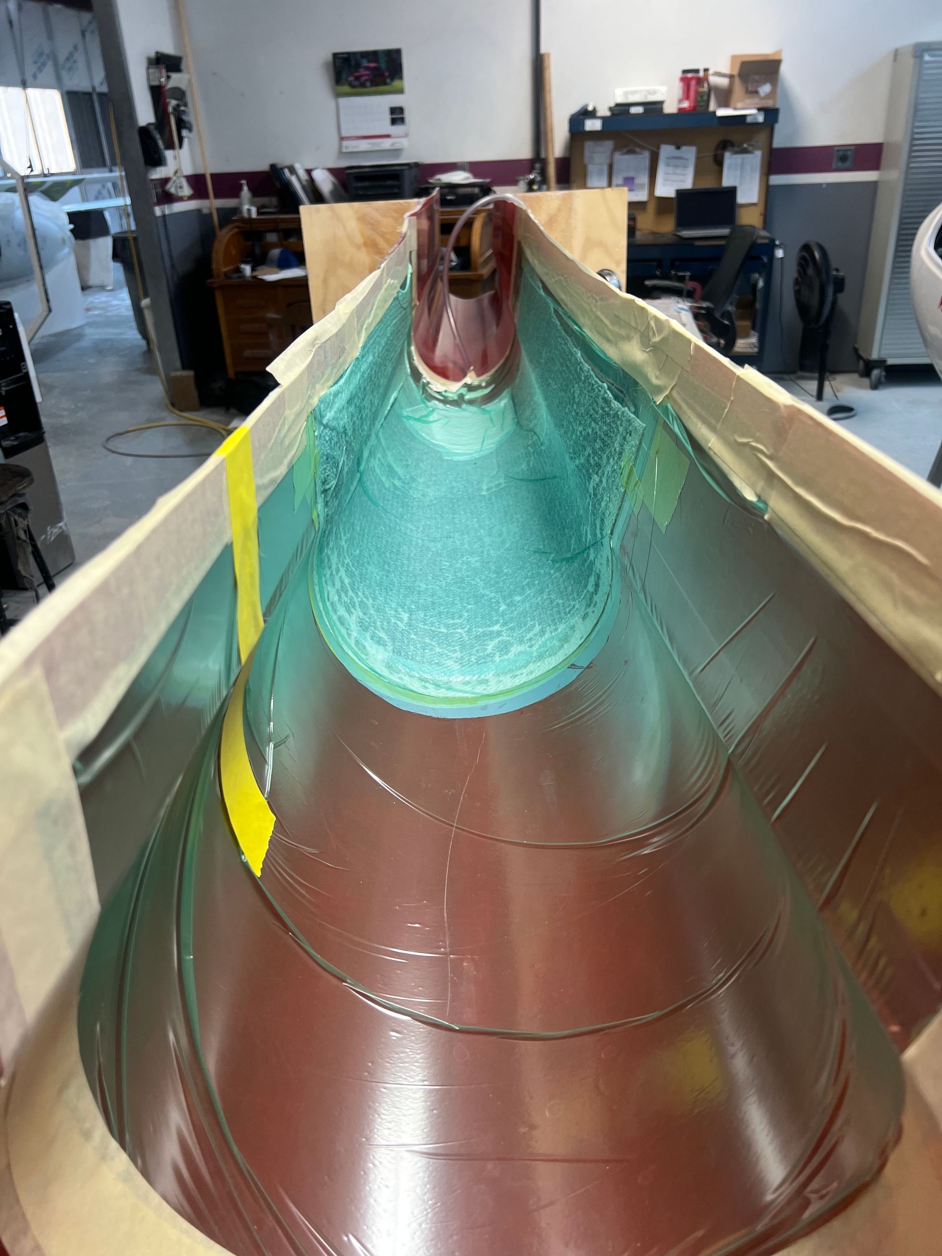 A large piece of metal is sitting on top of a wooden table in a room.
