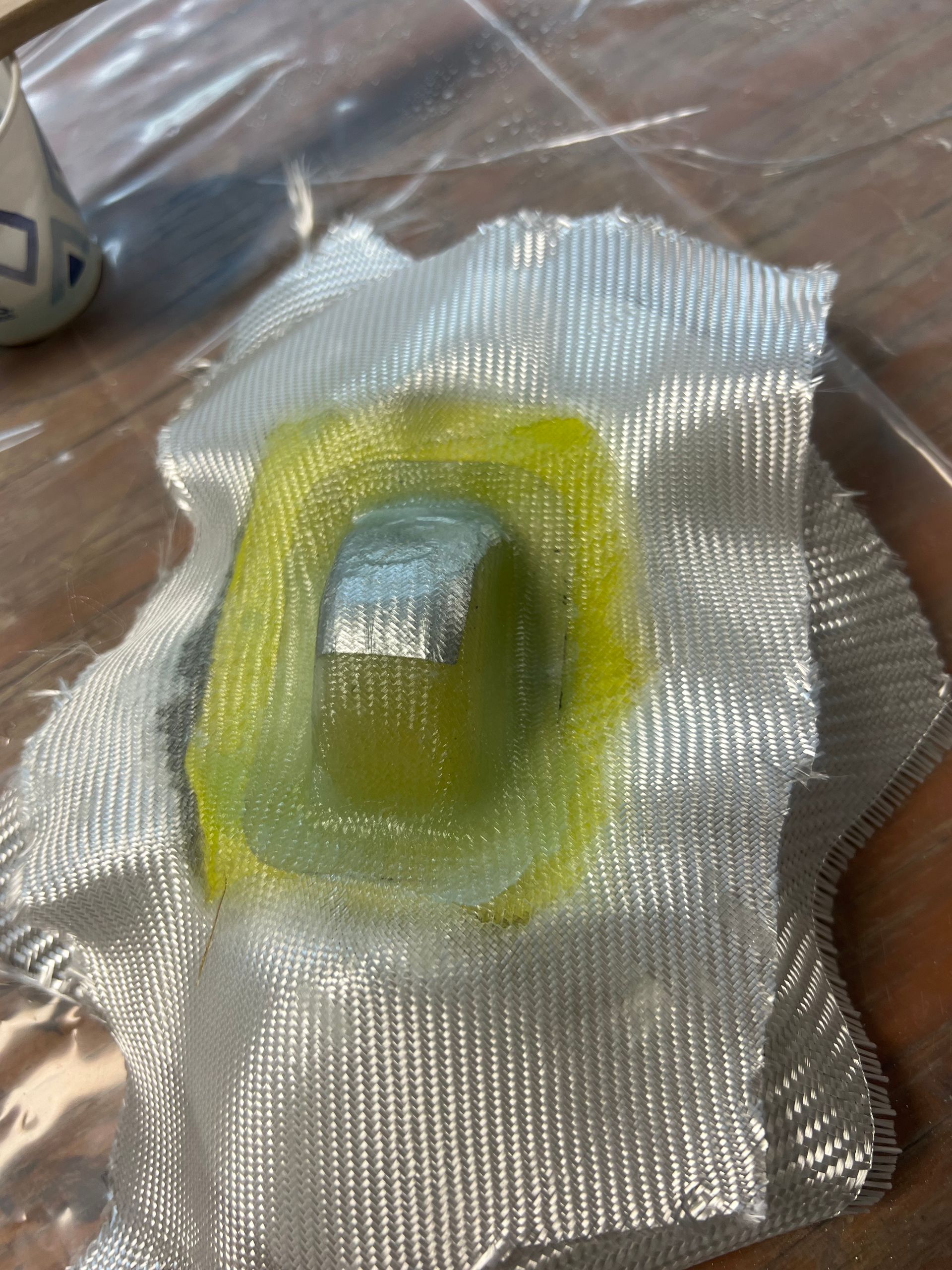 A close up of a piece of fabric with a hole in it on a table.