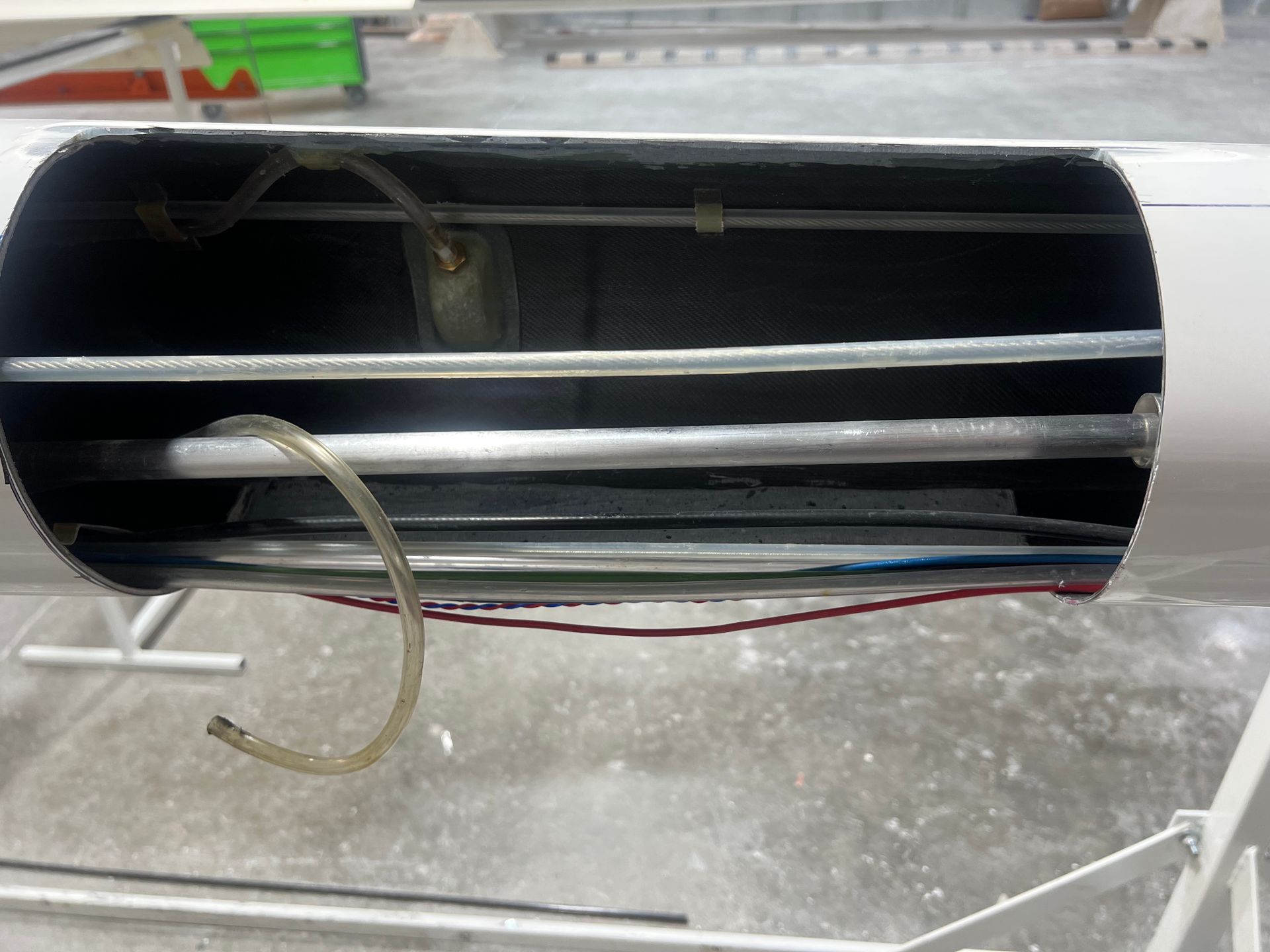 A white pipe with a hose attached to it