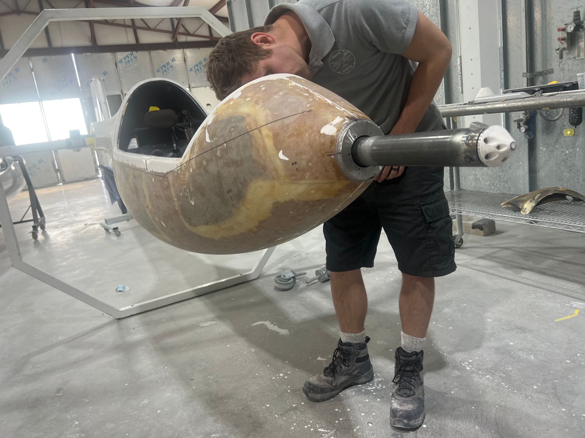 A man is standing next to a large object with his head on it