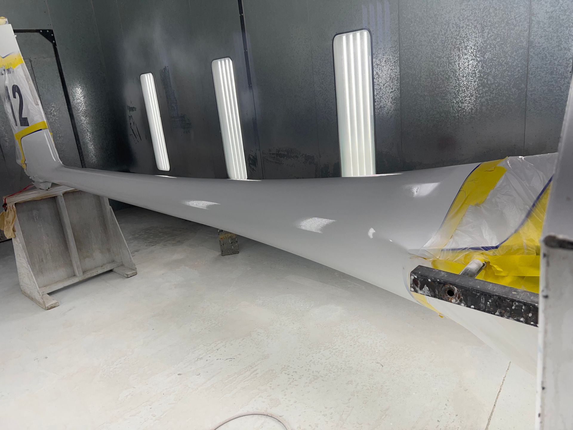 A large piece of metal is sitting on the floor in a room.