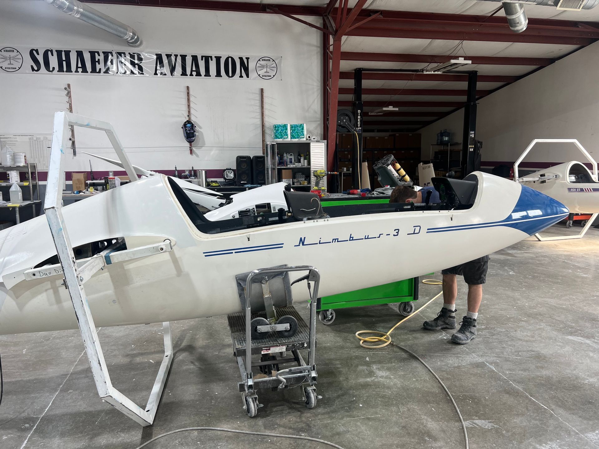 A plane in a hangar with a sign that says schaeffers aviation