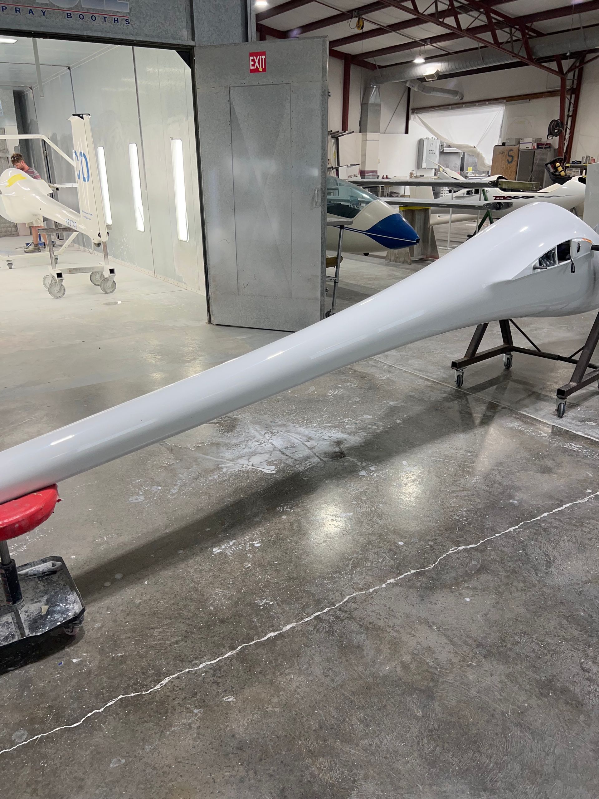 A large white object is sitting on a concrete floor in a warehouse.