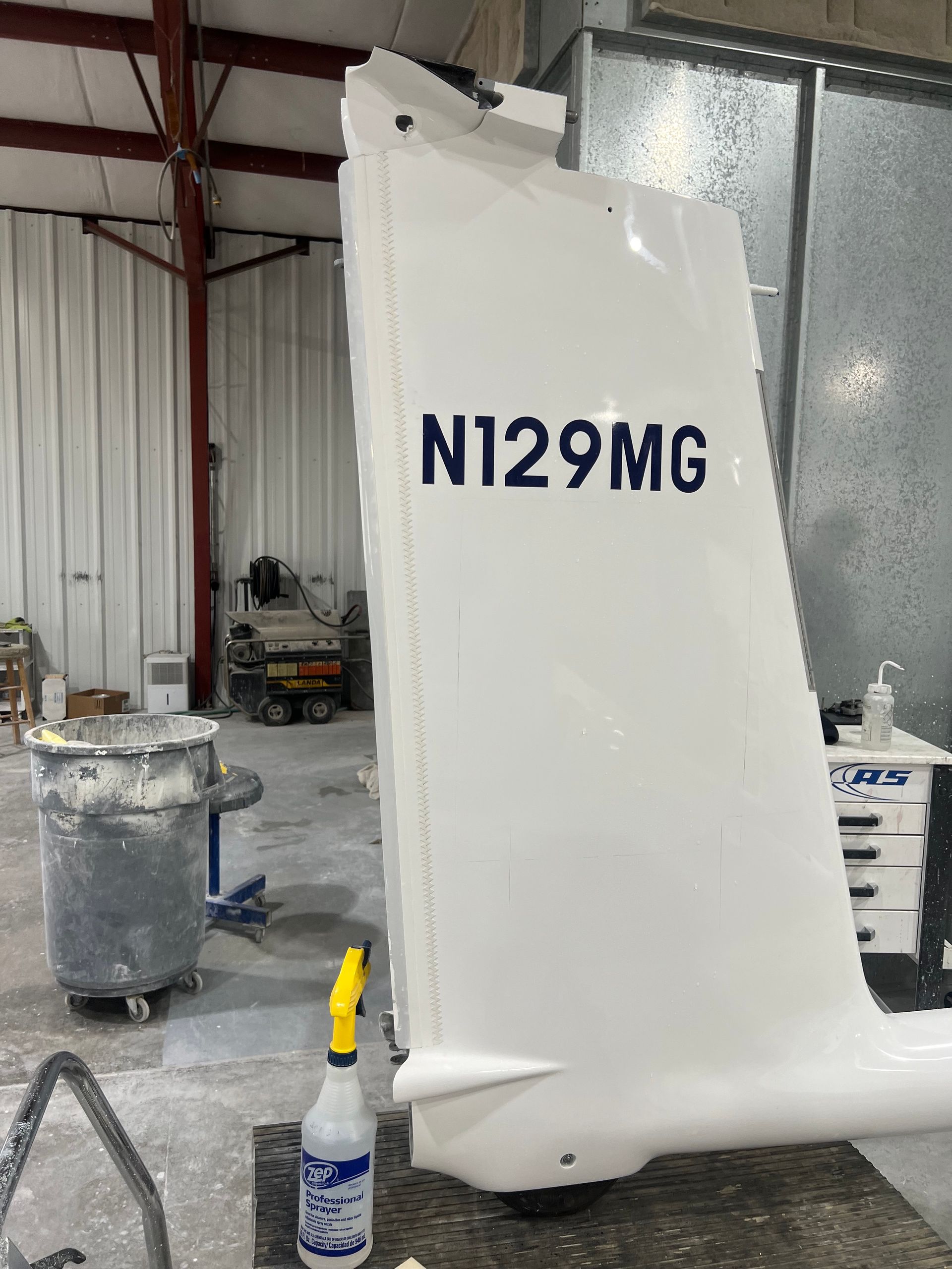 A white airplane wing with the numbers n129mg on it