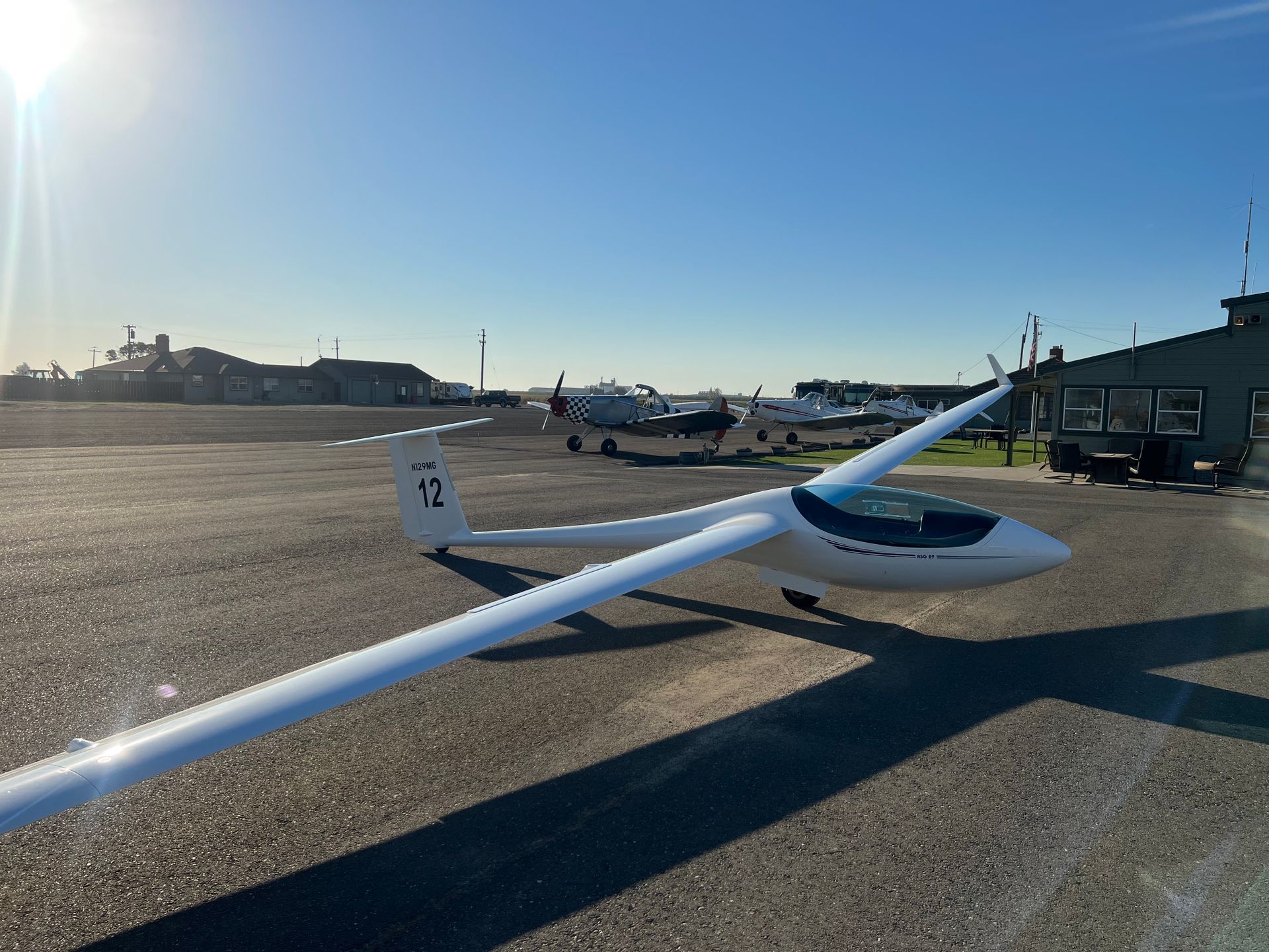A plane with the number 12 on the tail is parked on a runway