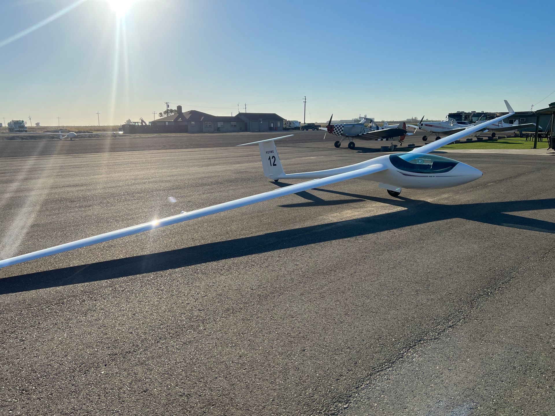 A small plane is parked on the tarmac at an airport