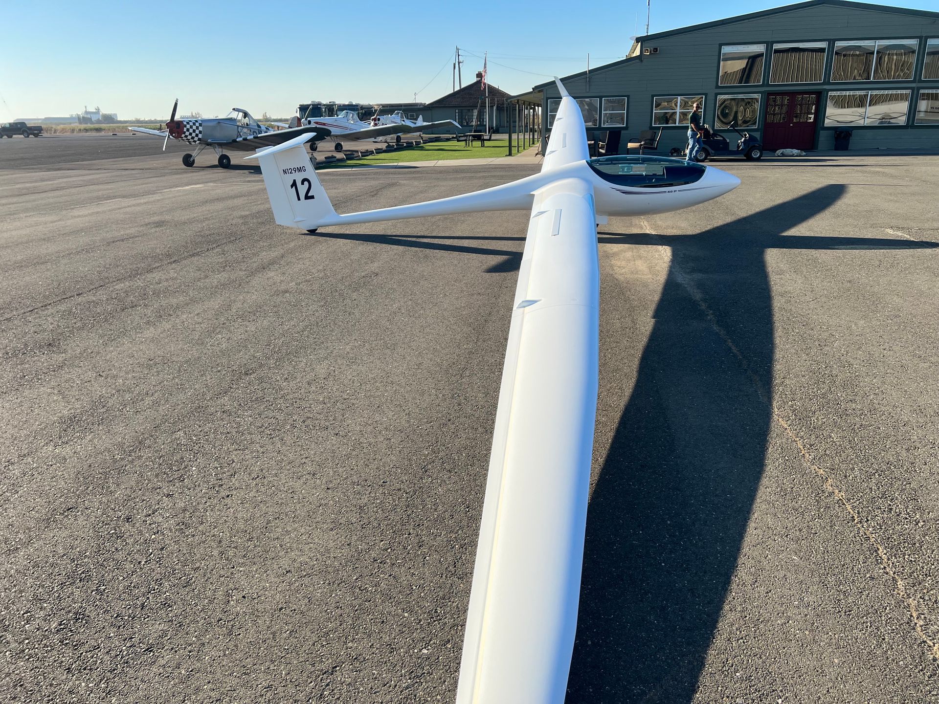 A white plane with the number 12 on the tail