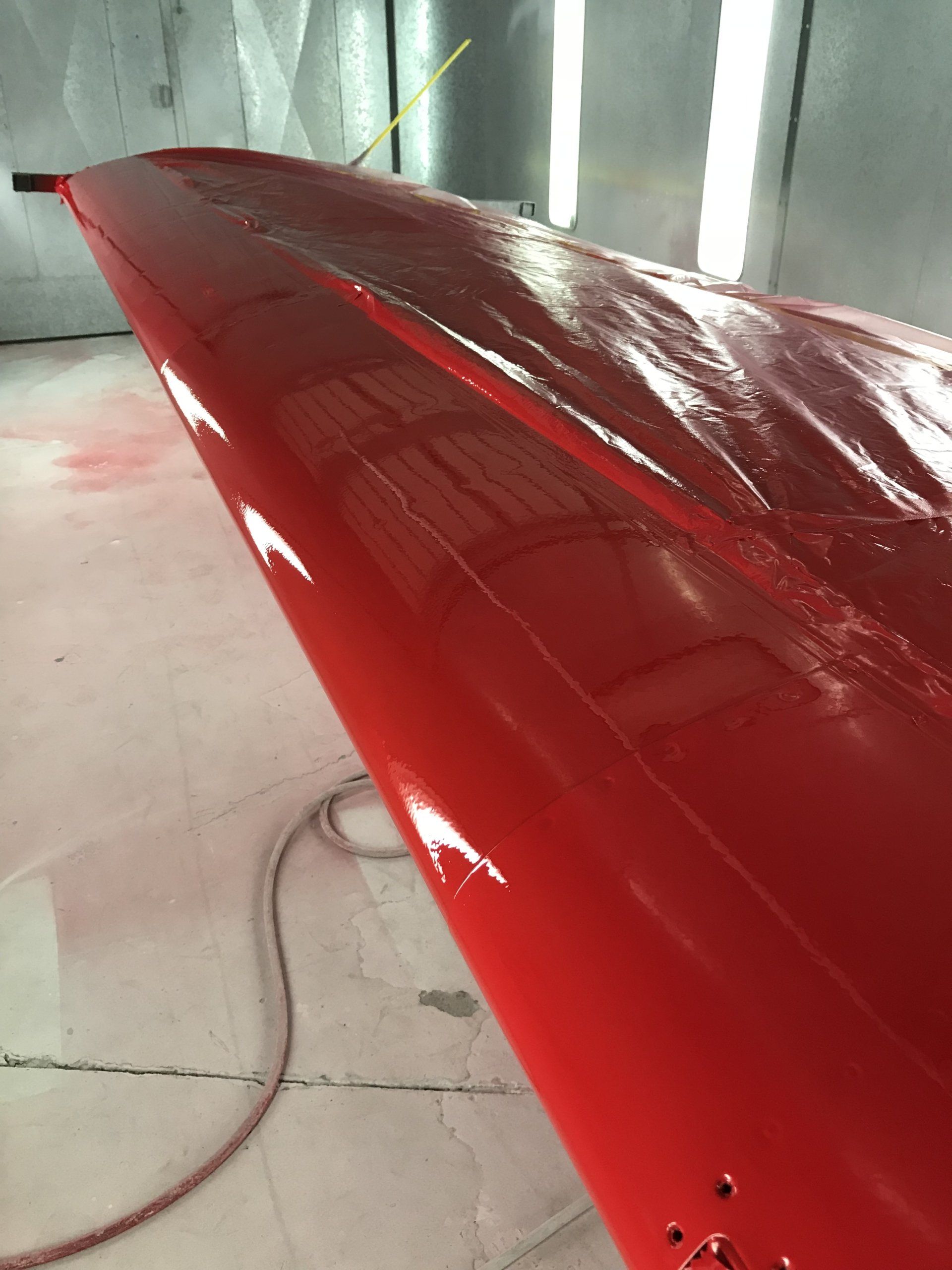 A red object is sitting on the floor in a room